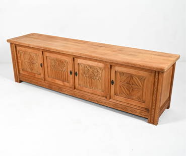 DANISH BRUTALIST OAK SIDEBOARD: With gothic-inspired carvings. Key included. c. 1970's. Dimension: H 25.75" x W 88" x D 20.5" Conditions: Presents well overall. Minor sun fading; a few scattered water spots and spots of soiling, a f