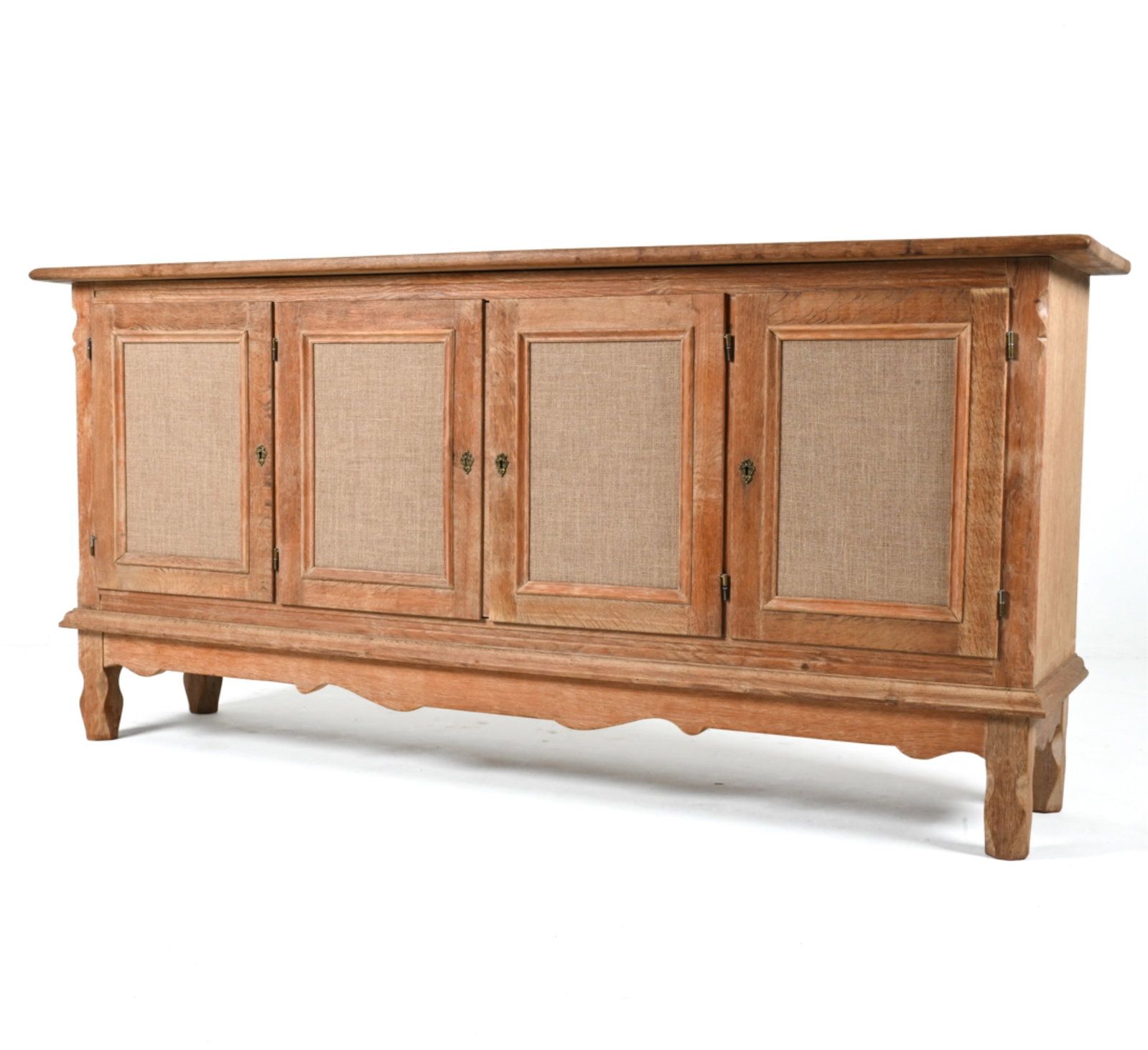 HENNING KJAERNULF-STYLE SCANDINAVIAN OAK SIDEBOARD: c. 1970's; later remodeled in the B. J. style with burlap-wrapped door panels. Key included. Dimensions: H 39.25" x W 82.25" x D 19.75" Condition: Stress crack, soiling and minor warping to top. Musty