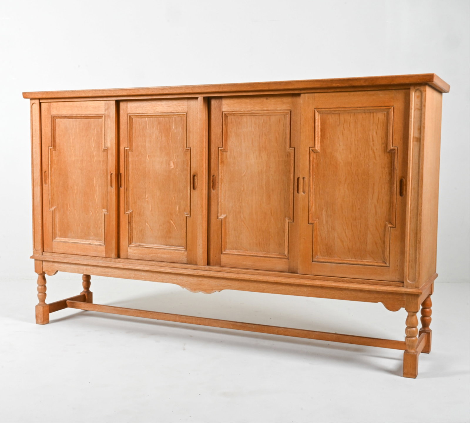 MANNER OF HENNING KJAERNULF OAK HIGHBOARD: Scandinavian, c. 1970's. Dimensions: H 47.25" x W 78.75" x D 18.5" Condition: A few spots of soiling, dings and scuffs. Wear consistent with age and use, Presents well overall. DMC065