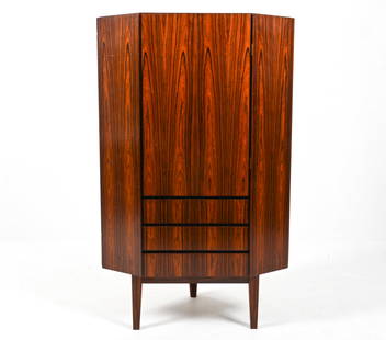 ATTR. GUNNI OMANN ROSEWOOD CORNER CABINET: Attributed to Gunni Omann for Omann Jun. Denmark, c. 1970's. Dimensions: H 59.25" x W 37" x D 24.5" Condition: Presents very well overall. Scattered dings and scuffs; a few minor chips along right edg