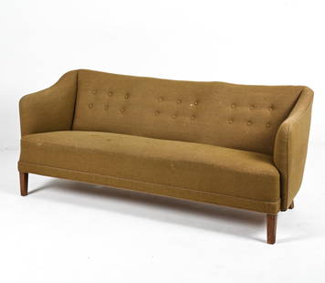 DANISH SOFA IN THE MANNER OF FINN JUHL, C. 1940'S: With beech legs. Dimensions: H 29" x W 71" x D 29" x SH 17" Condition: Chip and loss to back right leg. Great candidate for reupholstering; fabric with fading, tears, and spots of soiling. Wear consis