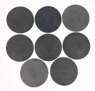 (8) MURIEL GRATEAU LARGE PORCELAIN PLATTERS: 8 ceramic concentric grooved platters, labeled underneath. In matte black. Dimensions: Dia 15" Condition: Some surface wear and marks from use.