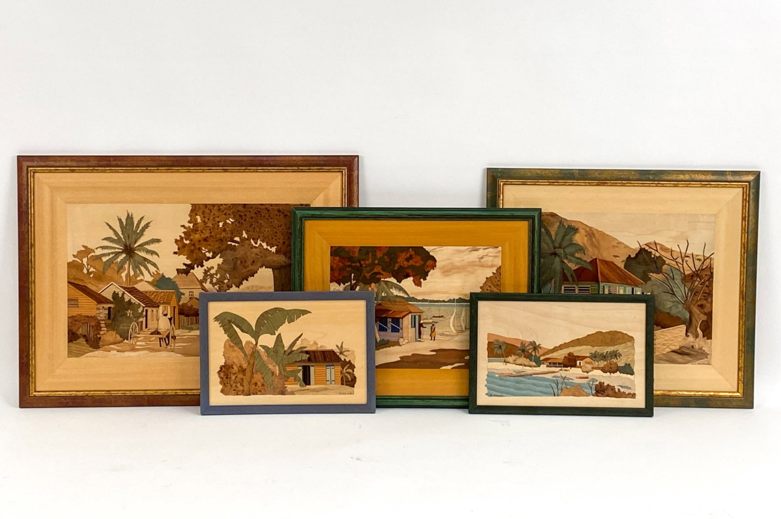 (5) JEAN PIERRE STRAUB HAITIAN INLAID WOOD ART: series of Haitian views in colored inlaid wood. All stamped on back. Artist of Jean Pierre Straub. All signed on front. Dimensions: (Largest frame) H 17" x W 23.5" Condition: Couple marks to frames.