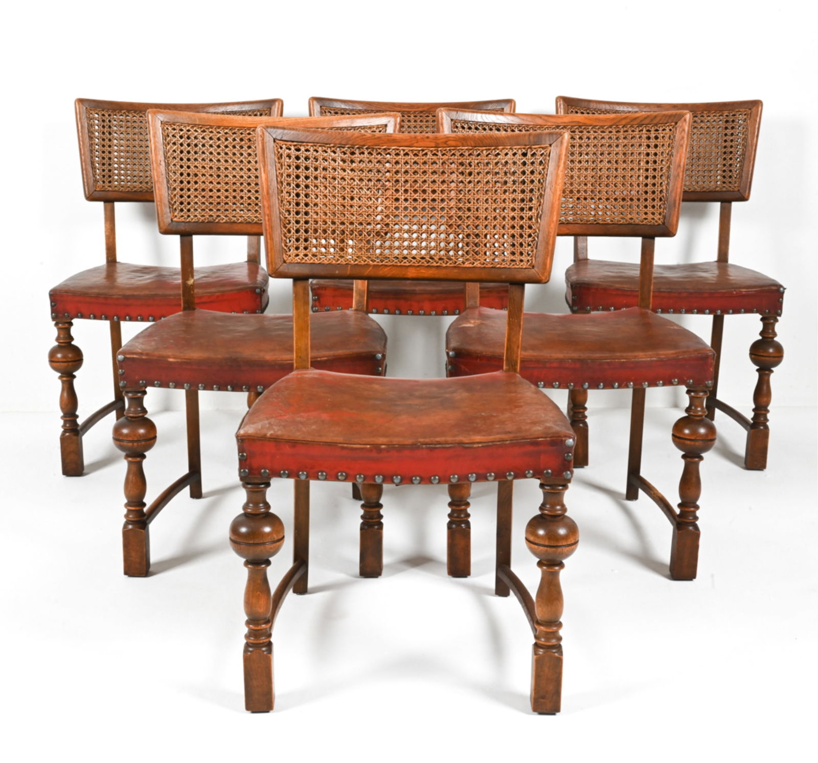 (6) SCANDINAVIAN CANED OAK & LEATHER DINING CHAIRS: c. Early- to Mid-20th Century. Dimensions: H 32.5" x W 19.25" x D 19.5" x SH 17" Condition: True semi-antique patina and surface wear. Soiling, a few cracks and small losses to leather. Missing one de
