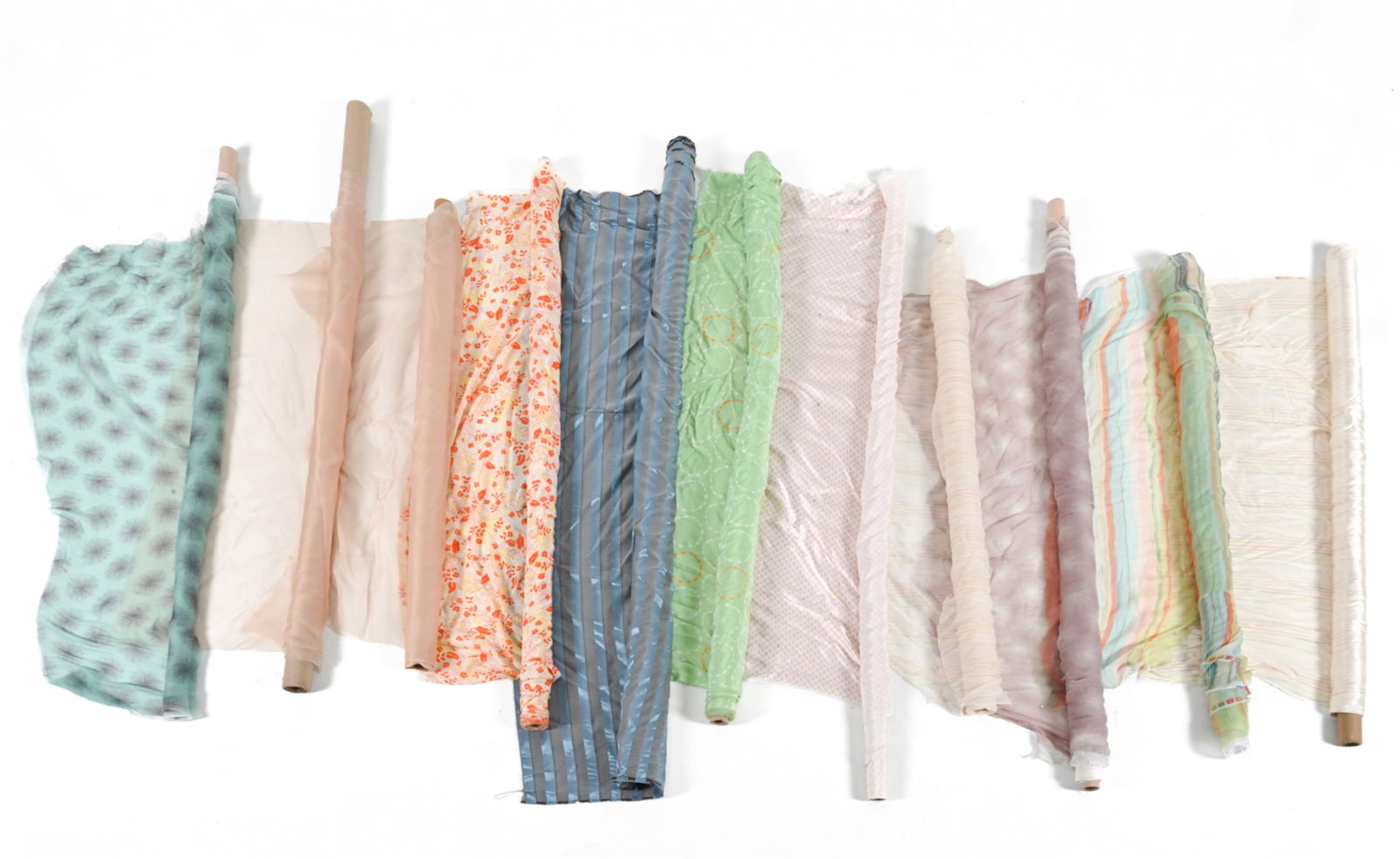 GROUPING OF FINE SILK & SILK-LIKE FABRICS: Including custom-designed prints. Dimensions: (Largest roll) L 63" x Dia. 3" Condition: Some soiling and tears to fabric ends. Overall light handling wear.