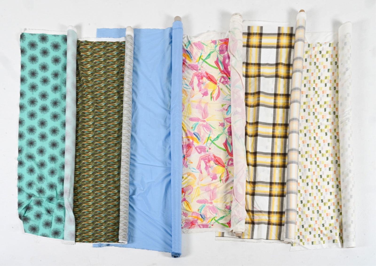 GROUPING OF COTTON & JERSEY FABRICS INCL. CUSTOM: Including several retro custom-designed prints. Dimensions: (Largest roll) L 62" x Dia. 3" Condition: Some soiling and tears to fabric ends. Overall light handling wear.
