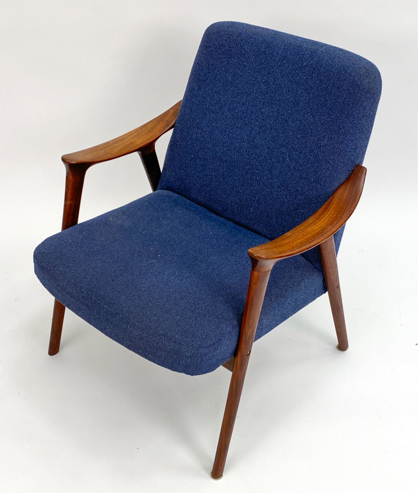 MID-CENTURY WESTNOFA TEAK ARMCHAIR: Dimensions: H 31" x W 26.5" x D 26" x SH 15.5" Condition: Missing several decorative wood screw covers. Frame with a few water spots, scuffs and rubs. Minor fading and a few faint spots of soiling to 