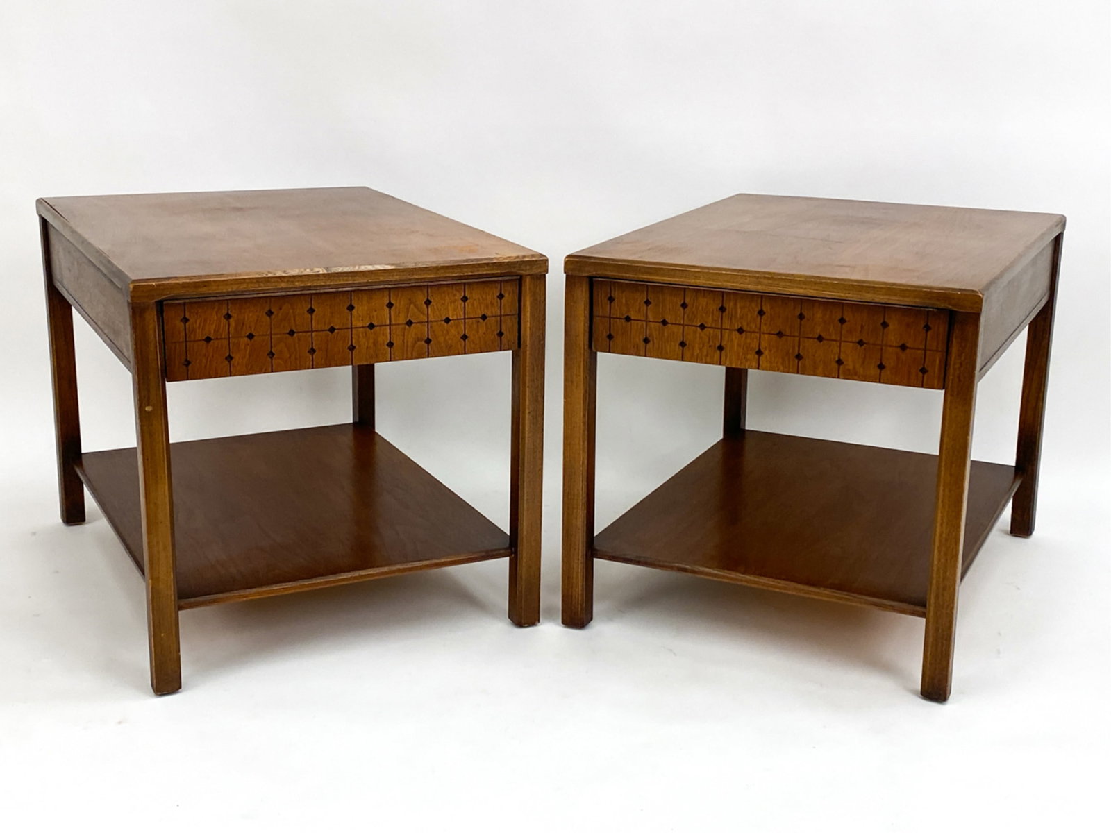 PAIR DEL MUNDO UNAGUSTA MID-CENTURY SIDE TABLES: Walnut. Marked on interior of drawers. Includes sales ticket stapled to underside of one. Dimensions: H 20.75" x W 21.25" x D 28.25" Condition: Some surface wear consistent with age and use. Couple di