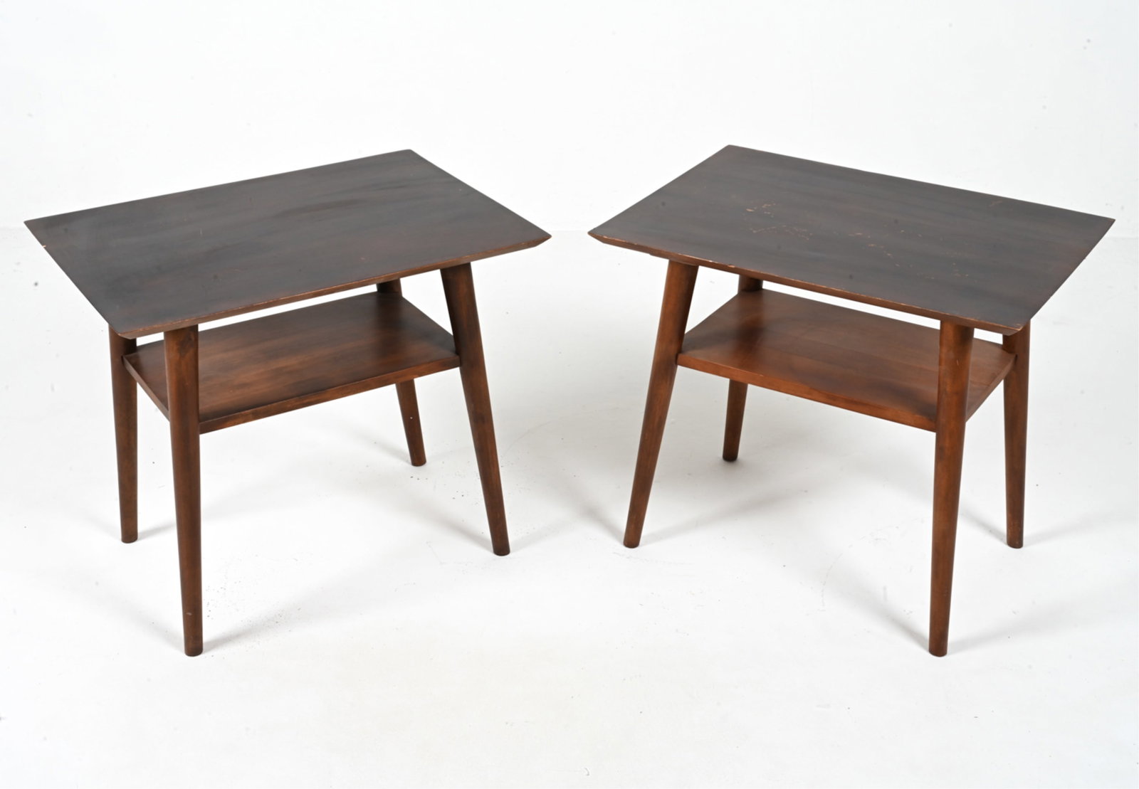 PAIR OF END TABLES IN THE MANNER OF PAUL MCCOBB: Mid-20th Century. Dimensions: H 20.75" x W 23.75" x D 17.25" Condition: Great candidates for refinishing; showing moderate surface wear consistent with age and use.