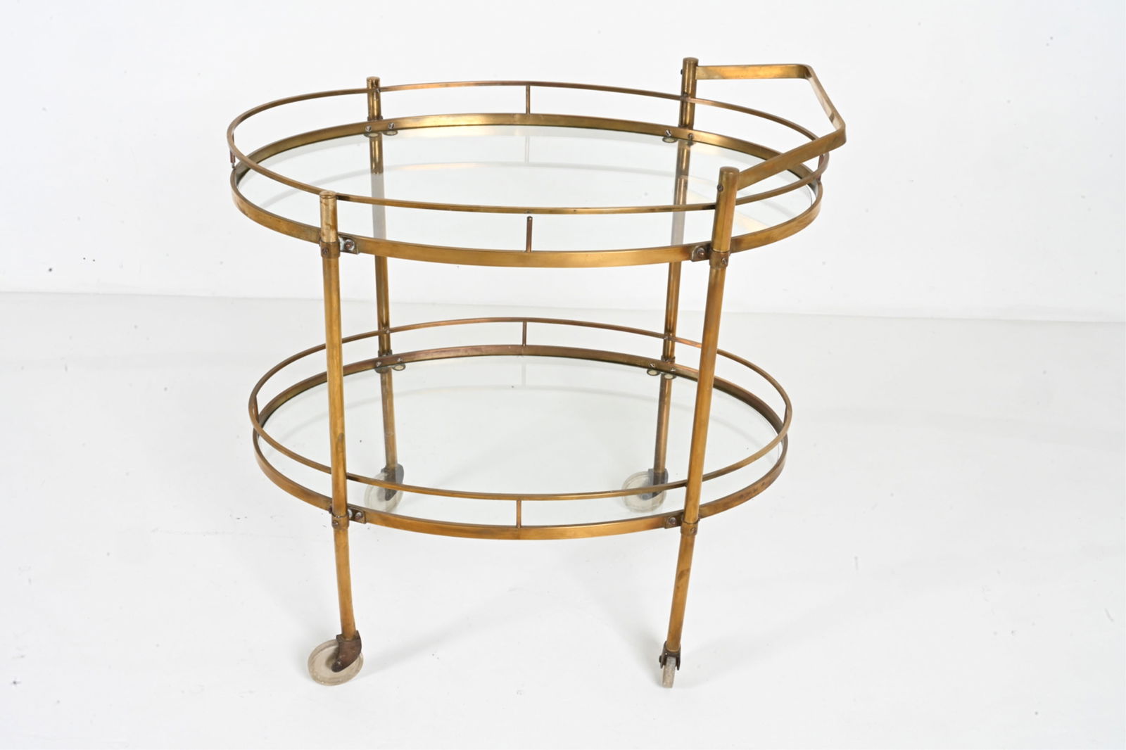 ATTR. MAXWELL-PHILLIPS BRASS & GLASS BAR CART: Oval tiered bar cart in brass and glass, attributed to Maxwell-Phillips of New York, c. 1960's. Dimensions: H 31.5" x W 29.5" x D 19.5" Condition: Presents well. Minor patination, a few small spots of