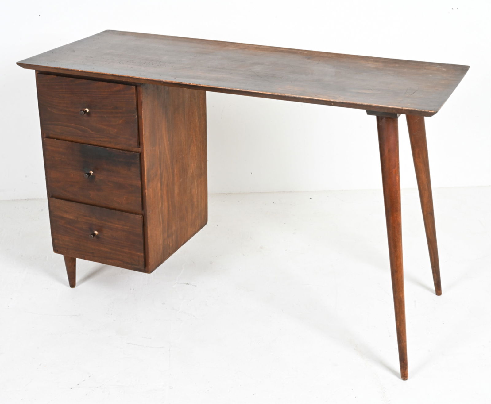 ATTR. PAUL MCCOBB PLANNER GROUP DESK: Paul McCobb 'Planner Group' writing desk with 3 drawers. Tapered angled legs. Mid-Century Modern. Dimensions: H 30" x W 48" x D 19.75". Condition: Wear as expected from regular use. Scratches, gouges,
