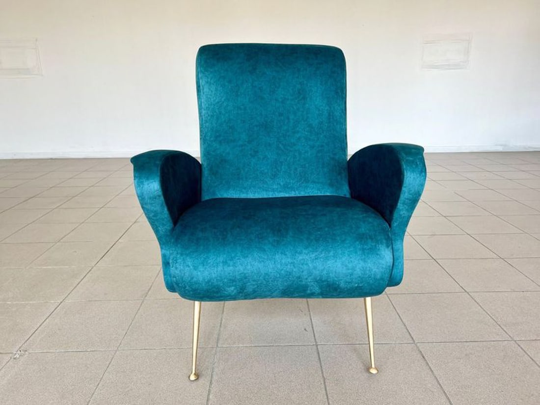 MID-CENTURY ARMCHAIR BY GIO PONTI C. 1960S: Vintage Armchair by Gio Ponti, 1960s. Newly upholstered in blue fabric with 4 brass legs. Dimensions: H 36.6" x W 29" x D 19.6" x SH 17.7" Condition: Like new, reupholstered.