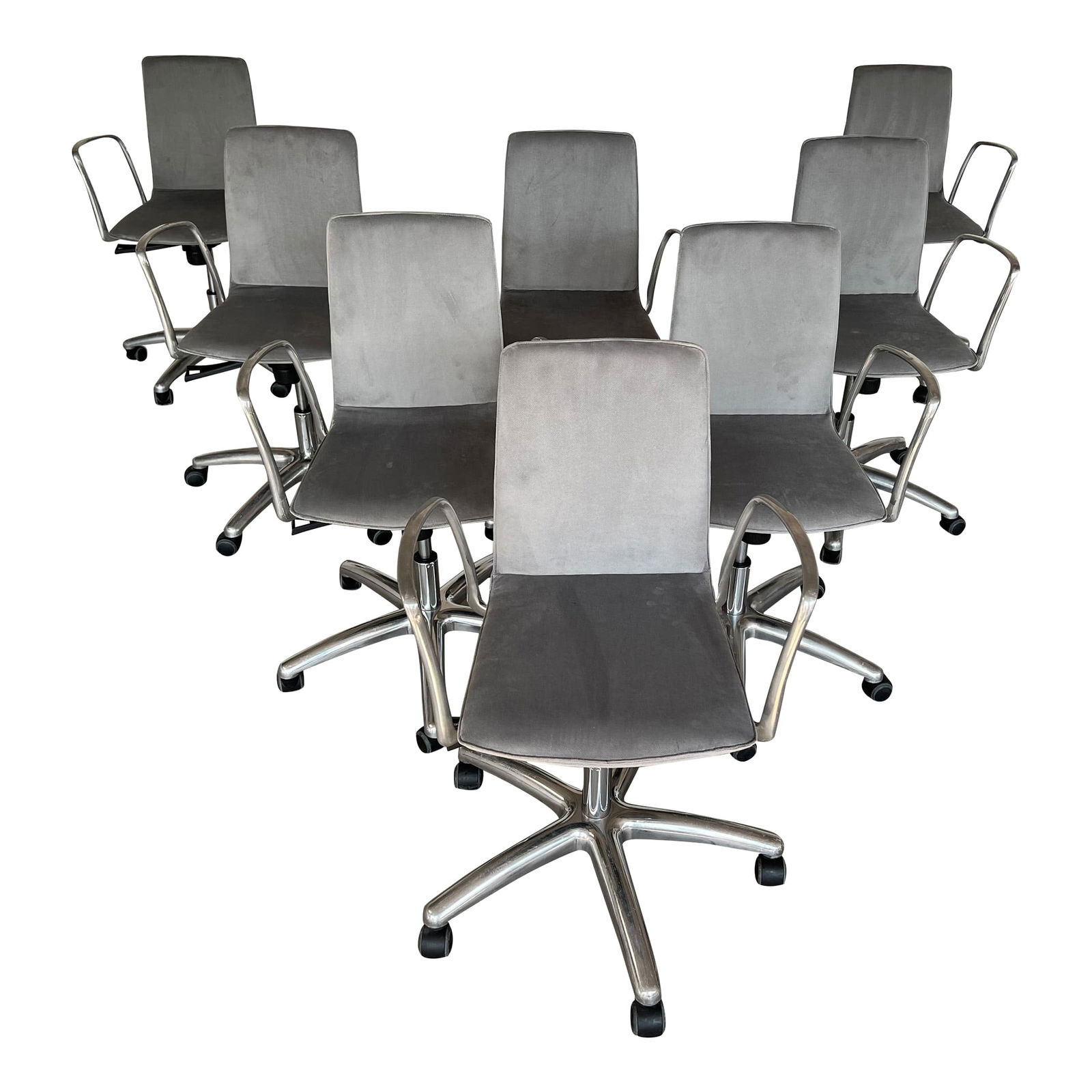 (8) CHAIRS IN THE STYLE OF JORGE PENSI: Set of 8 office chairs, made in the style of Jorge Pensi. Each chair has a 5 legs base in polished aluminum, gas cylinder elevation with tilt mechanism. A weight-activated synchro-tilt mechanism integ