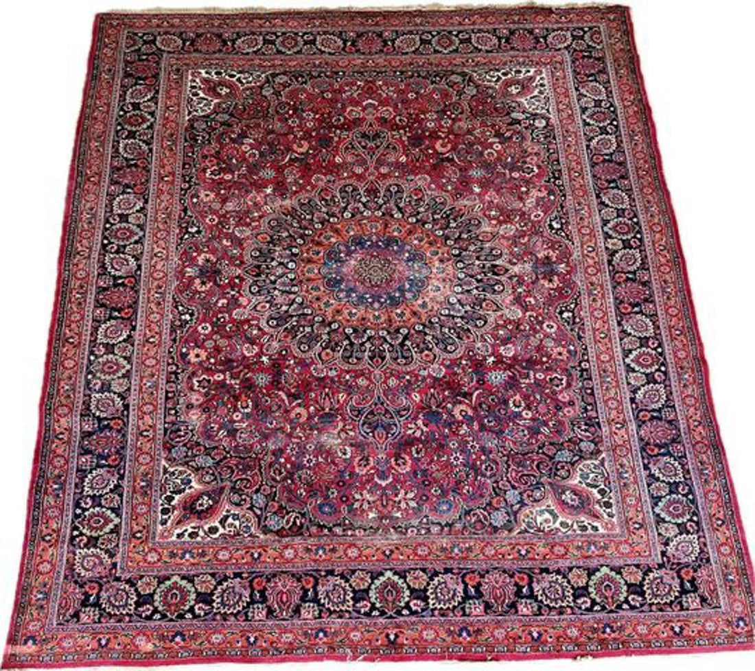 HAND KNOTTED PERSIAN MOUD WOOL RUG: Floral deign on a red background with a center medallion. Minor wear and fading, minor fringe damage. Dimensions: H 161" x W 118" Condition: Vintage condition corresponding to age.