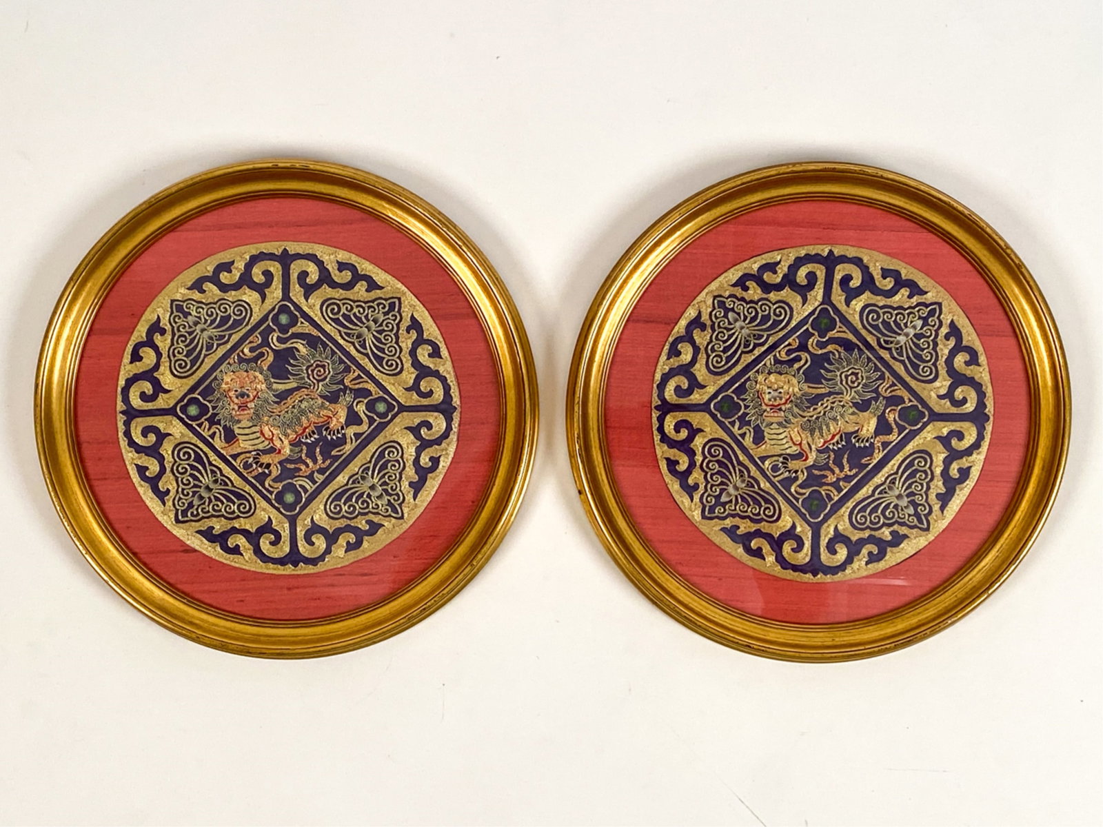 PAIR OF VINTAGE CHINESE EMBROIDERIES: Embroideries of foo lions in silk and gold thread. Dimensions: (Frame) Dia 16" (Sight) Dia 10.25" Condition: Some marks to the frame.