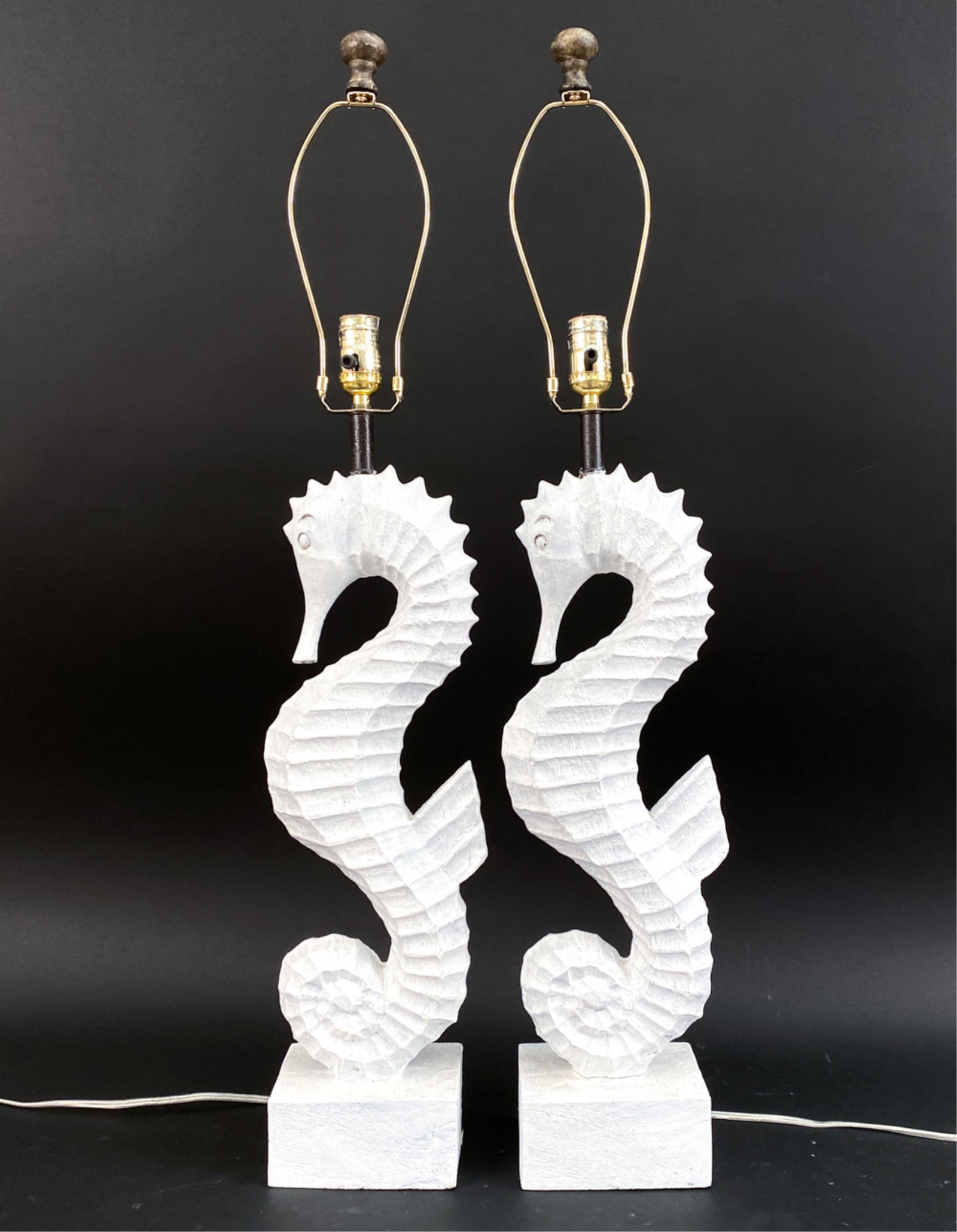 PAIR OF VINTAGE FIBERGLASS SEAHORSE LAMPS: painted faux carved wood. Dimensions: (To finial) H 37" x W 7.25" x D 5" Condition: One with crack to top, other coming off base. Untested.