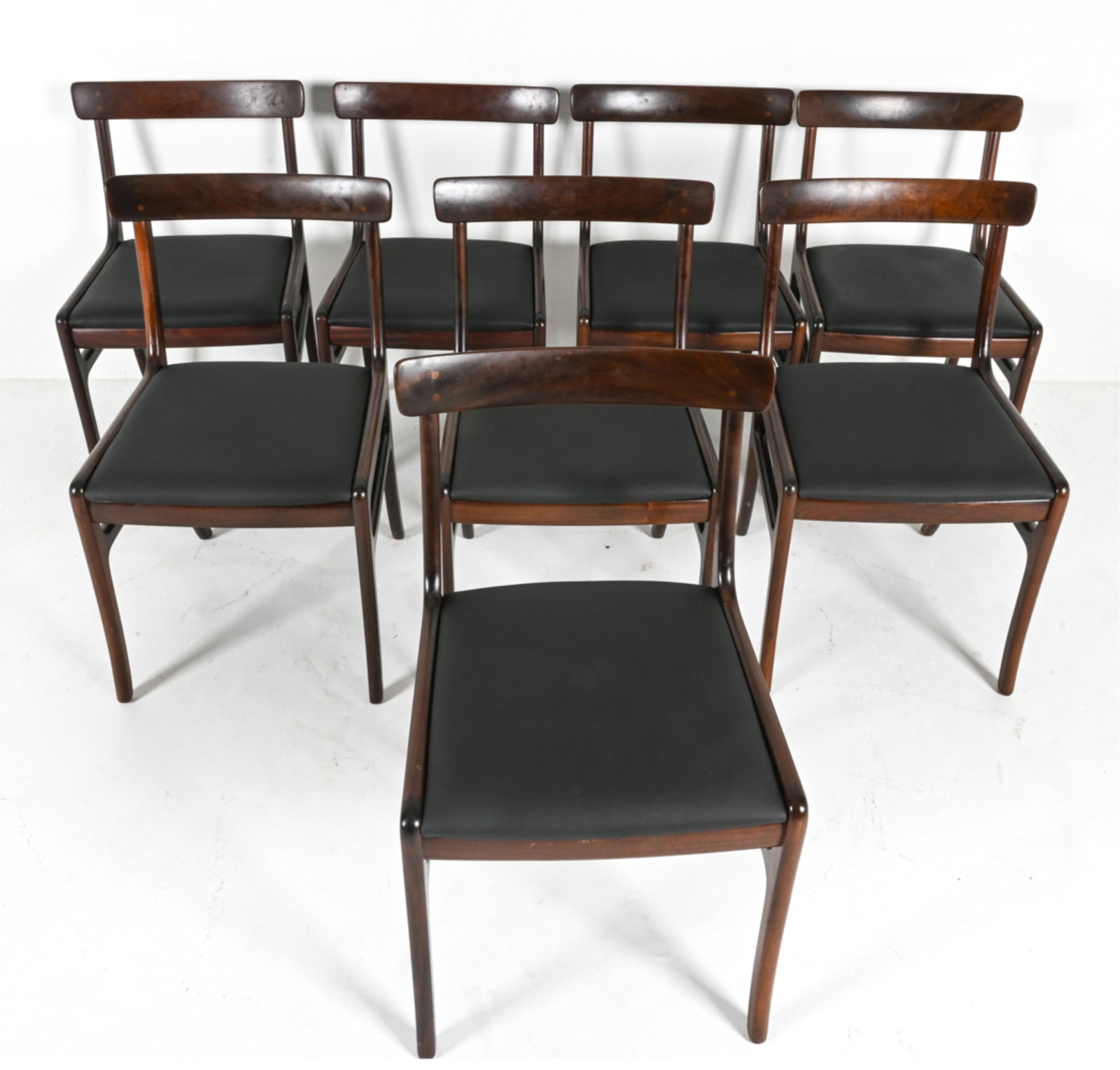 (8) OLE WANSCHER RUNGSTEDLUND MAHOGANY CHAIRS: (8) Solid mahogany side chairs from the iconic "Rungstedlund" series, designed by Ole Wanscher for Poul Jeppesen Mobelfabrik, Denmark, c. 1960's. Upholstered in black vegan leather. Labeled on seat ra