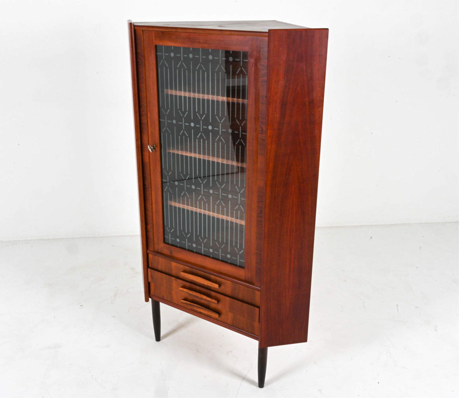ATTR. OMANN JUN DANISH ROSEWOOD CORNER CABINET: Mid-century Modern corner display cabinet with etched glass door and two drawers. Rosewood veneer accents throughout. Attributed to Omann Jun. Denmark, Circa 1950's. Key included. Dimensions: H 57.75"