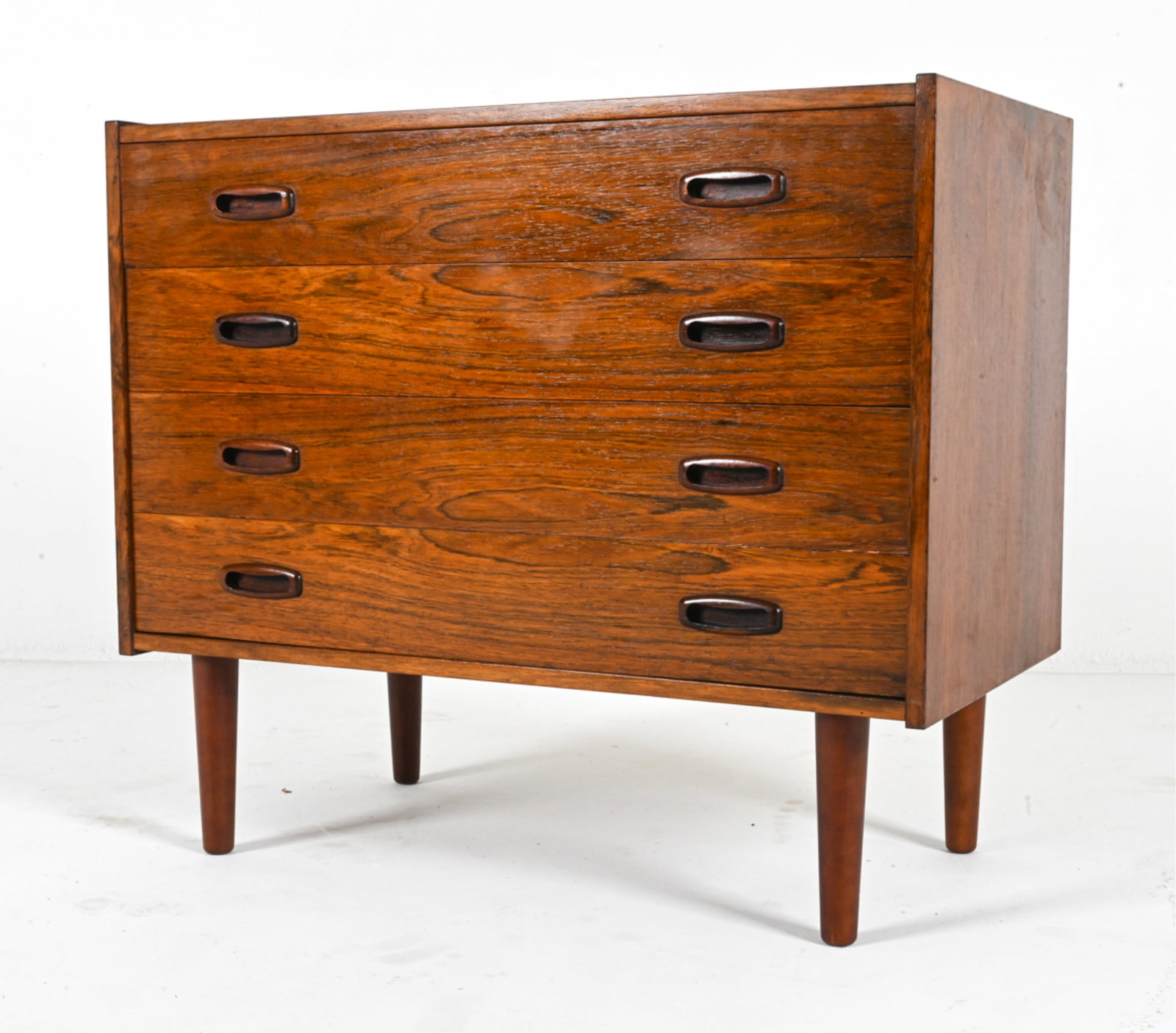 DANISH MID-CENTURY ROSEWOOD CHEST OF DRAWERS: Small chest of drawers with sculpted pulls. Circa 1960's. Dimensions: H 27.5" x W 31.5" x D 16.5". Condition: Wear expected from age and use. DMD 111