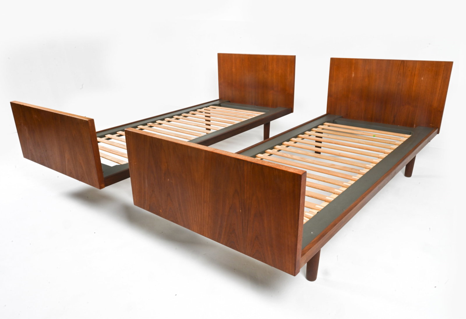 (2) HANS WEGNER FOR GETAMA TEAK TWIN DAYBEDS: Maker's mark on headboard. Denmark, c. 1960's. Dimensions: H 29.75" x W 81" x D 34.25". Condition: Thin surface scratches, areas of discoloration on wood. Wear consistent with age and use. B182