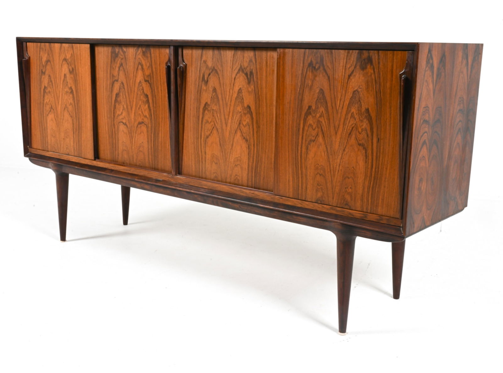 GUNNI OMANN FOR OMANN JUN ROSEWOOD SIDEBOARD: With sculpted dart-form door handles. Denmark, c. 1960's. Dimensions: H 34.5" x W 71" x D 18". Condition: Scuffs, small scratches on edges, underside. B168