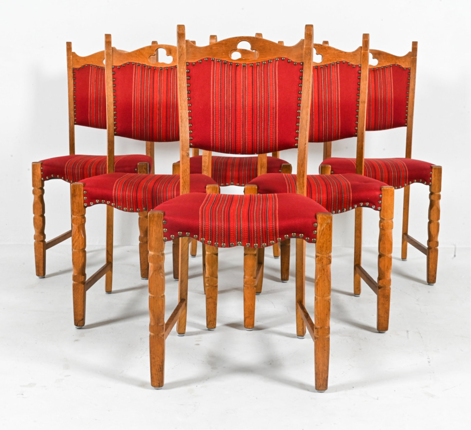 (6) MANNER OF HENNING KJAERNULF OAK DINING CHAIRS: With trefoil cutouts. Scandinavian, c. 1970's. Dimensions: H 37.25" x W 18.25" x D 17.5" x SH 17.5". Condition: Some wear and soiling to wood, as expected from age and use. B076
