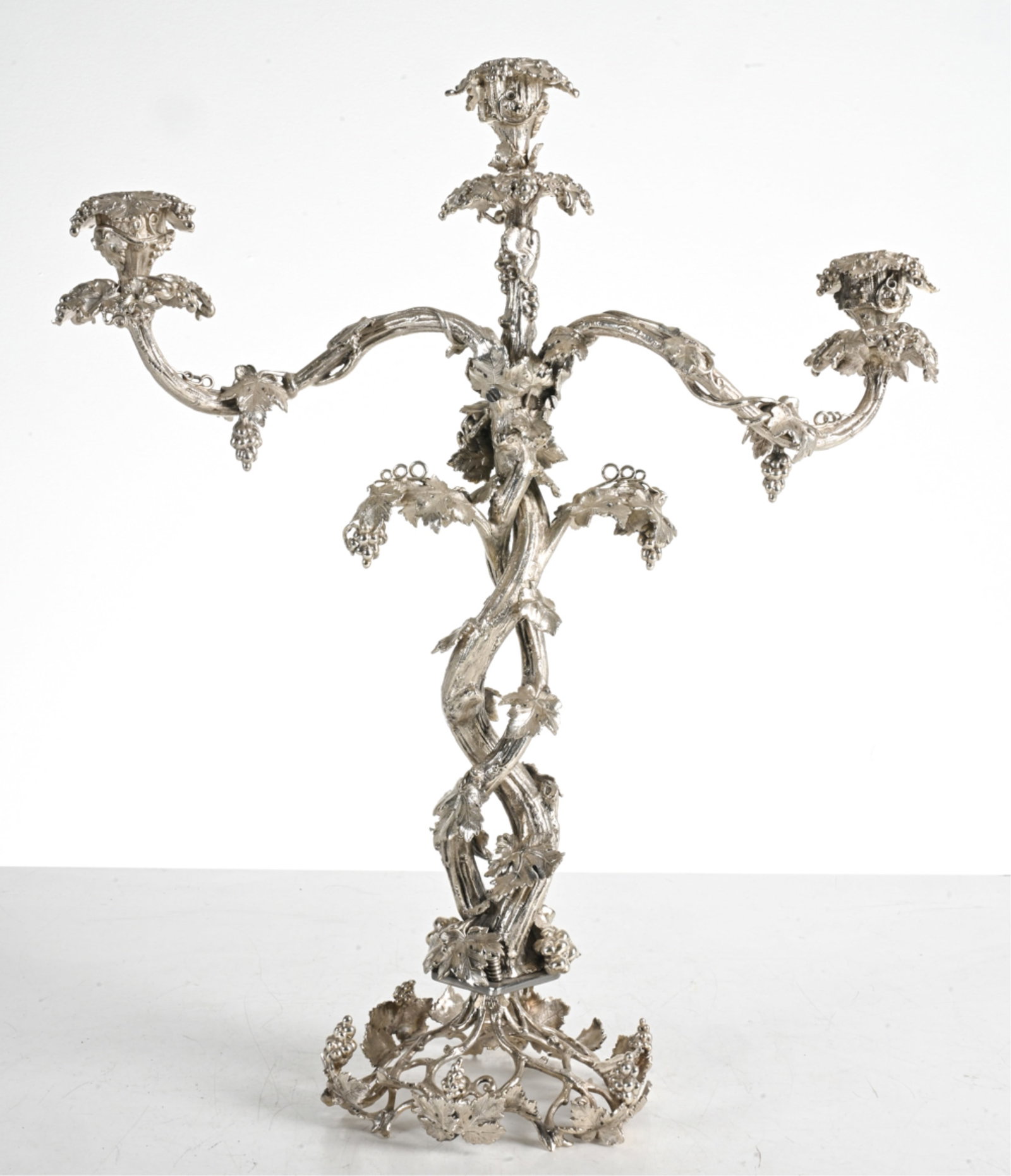 SILVERPLATE FAUX-BOIS CANDELABRA: Form of fruiting grape vines. Dimensions: H 21" x W 18" x D 6.5". Condition: Minimal surface wear. One small crack and old weld repair to underside of foot.