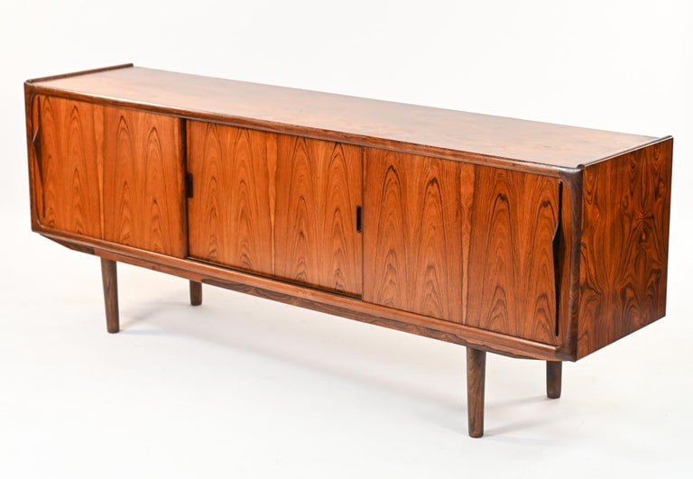 ERIK WORTS FOR NORDEN ROSEWOOD SIDEBOARD: Rosewood sideboard with mahogany interior, designed by Erik Worts for Norden Mobelfabrik; Denmark, c. 1960's. Labeled on back panel. Dimensions: H 31" x W 81" x D 19" Condition: Minor sun fading; ligh