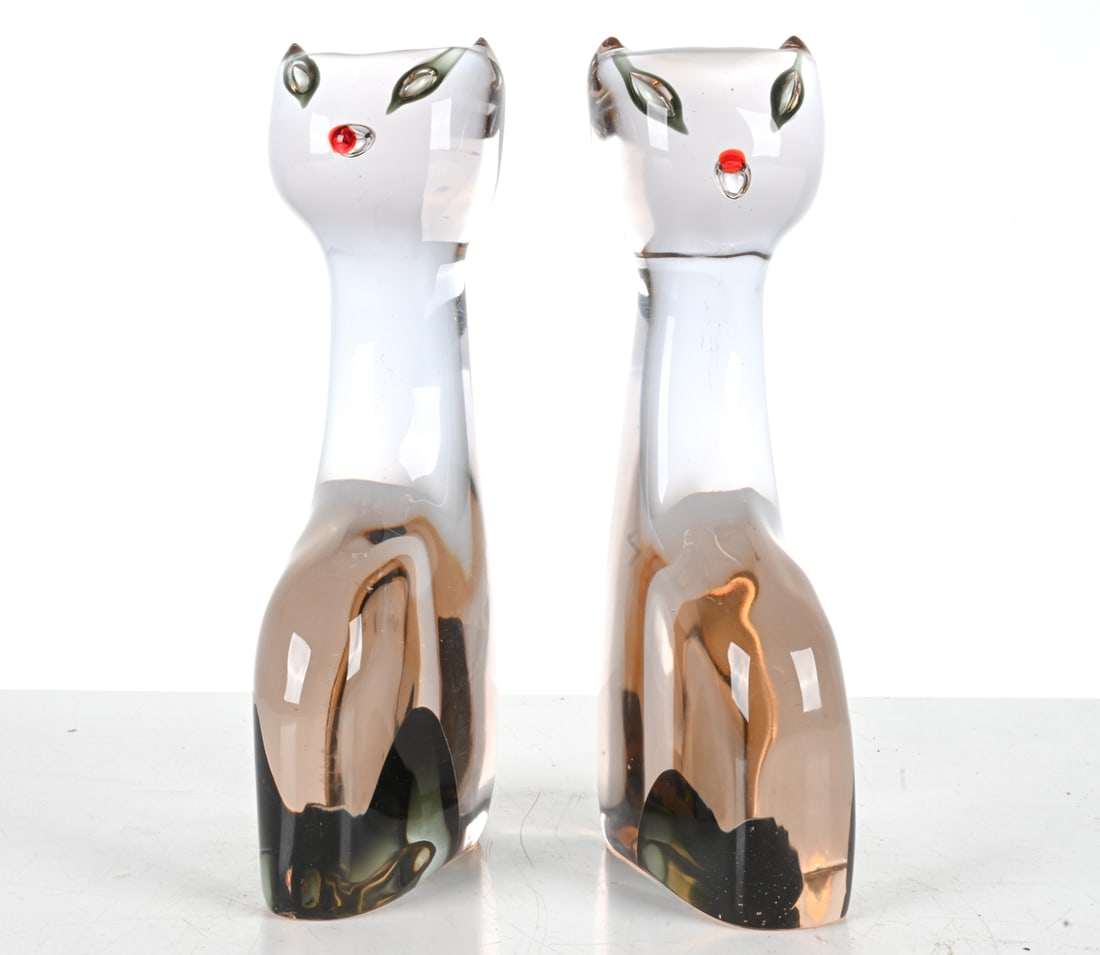 (2) ANTONIO DA ROS FOR CENEDESE MURANO GLASS CATS: Rare pair of Murano glass sculptures or bookends in the form of cats, designed by Antonio da Ros for Cenedese, c. 1960's. Tinted glass with sommerso technique at the legs, trapped bubbles and cased ac