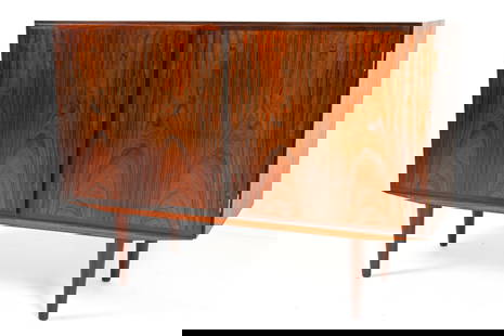 ATTR. GUNNI OMANN ROSEWOOD CABINET: Two-door credenza with adjustable shelves. Attributed to Gunni Omann for Omann Jun. Denmark, circa 1960's. Dimensions: H 33.5" x W 47" x D 17.25". Condition: Slight tobacco odor. Legs do not appear to