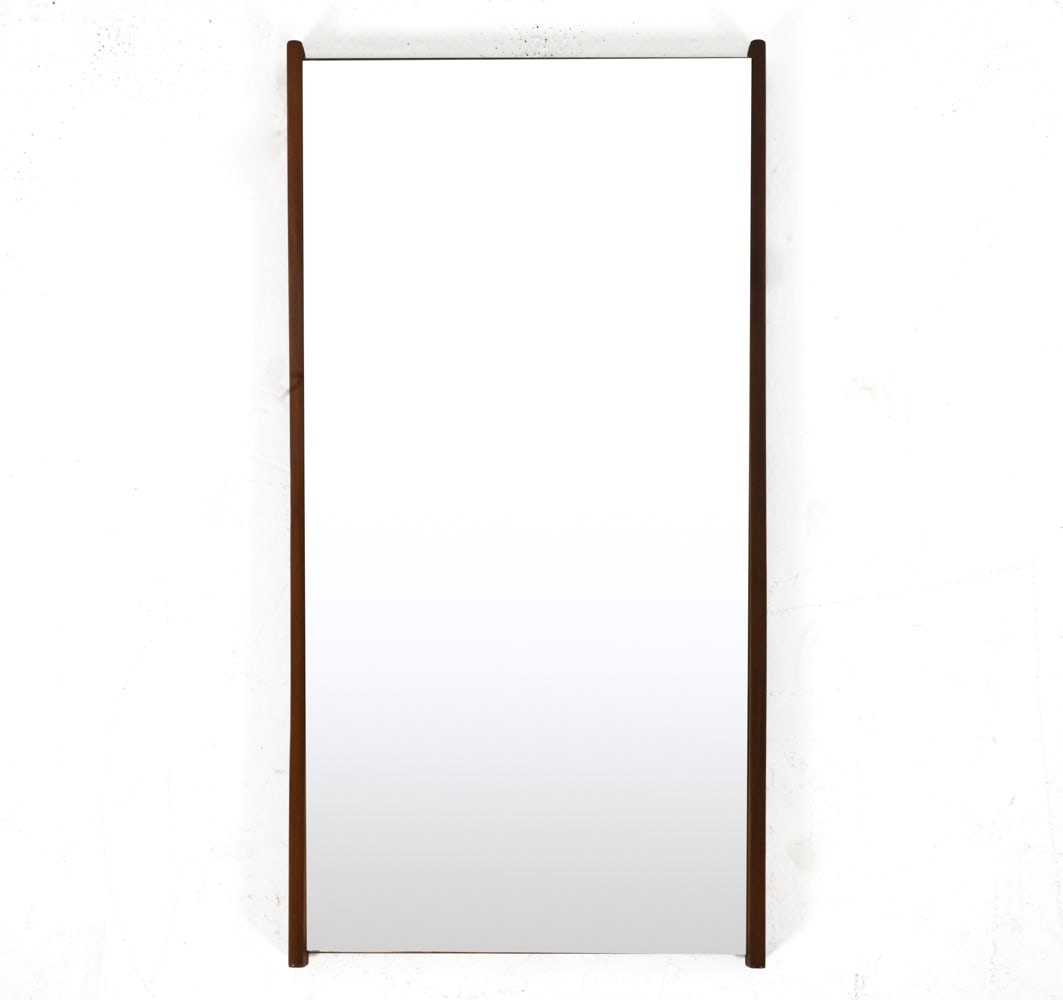 DANISH MID-CENTURY MINIMALIST TEAK MIRROR: Solid teak frame. c. 1960's. Dimensions: H 38.25" x W 19.5" x D 1.75". Condition: Slight sun fading; minor stress crack to wood at bottom right corner. Glass with a couple faint scratches; two small s