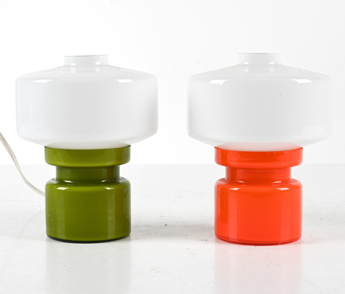 (2) HOLMEGAARD CASED GLASS TABLE LAMPS: Colorful cased hooped glass bases, with white opaline glass mushroom shades. Denmark, circa 1970's. Dimensions: H 6.75" x Dia. 5". Condition: Wires cut, require rewiring. No issues to note. C067