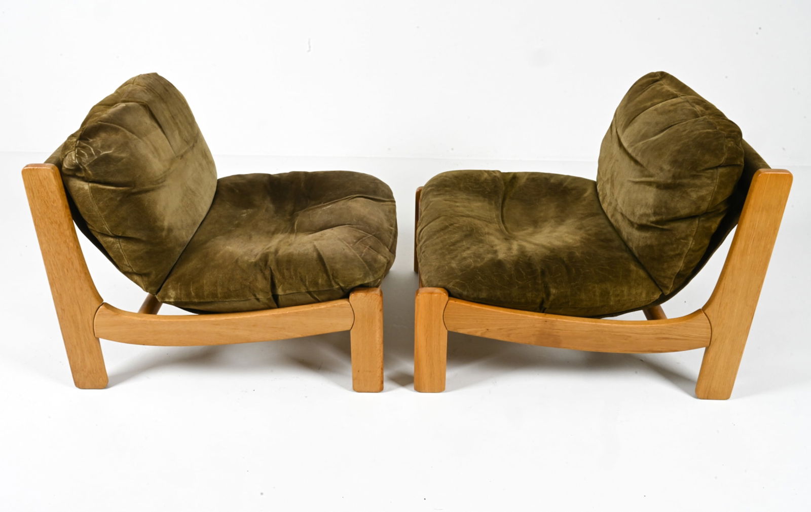 (2) BRUTALIST MODULAR LOUNGE CHAIRS IN OAK & SUEDE: Likely Swedish; c. 1970's. Dimensions: H 26.75" x W 28.5" x D 35". SH 14.5". Condition: Signs of wear to cushions, fabric backing. C158