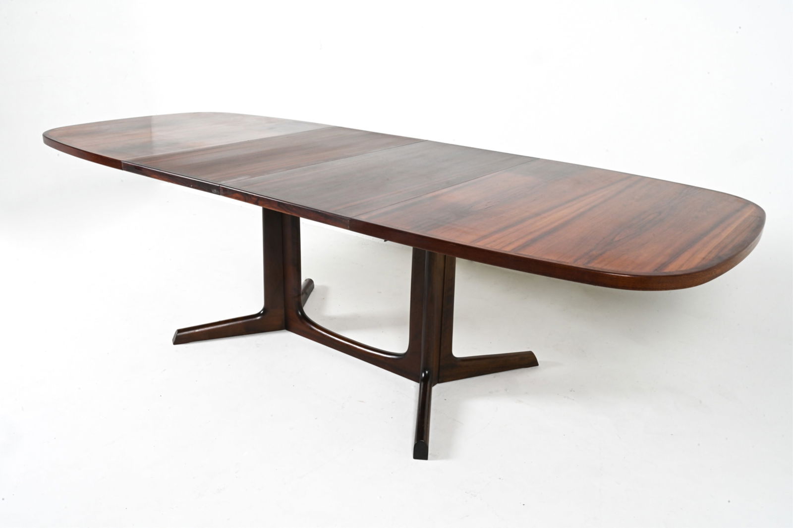 NIELS OTTO MOLLER FOR GUDME ROSEWOOD DINING TABLE: With (2) inset leaves. Gudme Mobelfabrik. Denmark, c. 1960's. Dimensions: H 28.25" x W 63.75" x D 41.25". Condition: Some warping of the veneer on top.