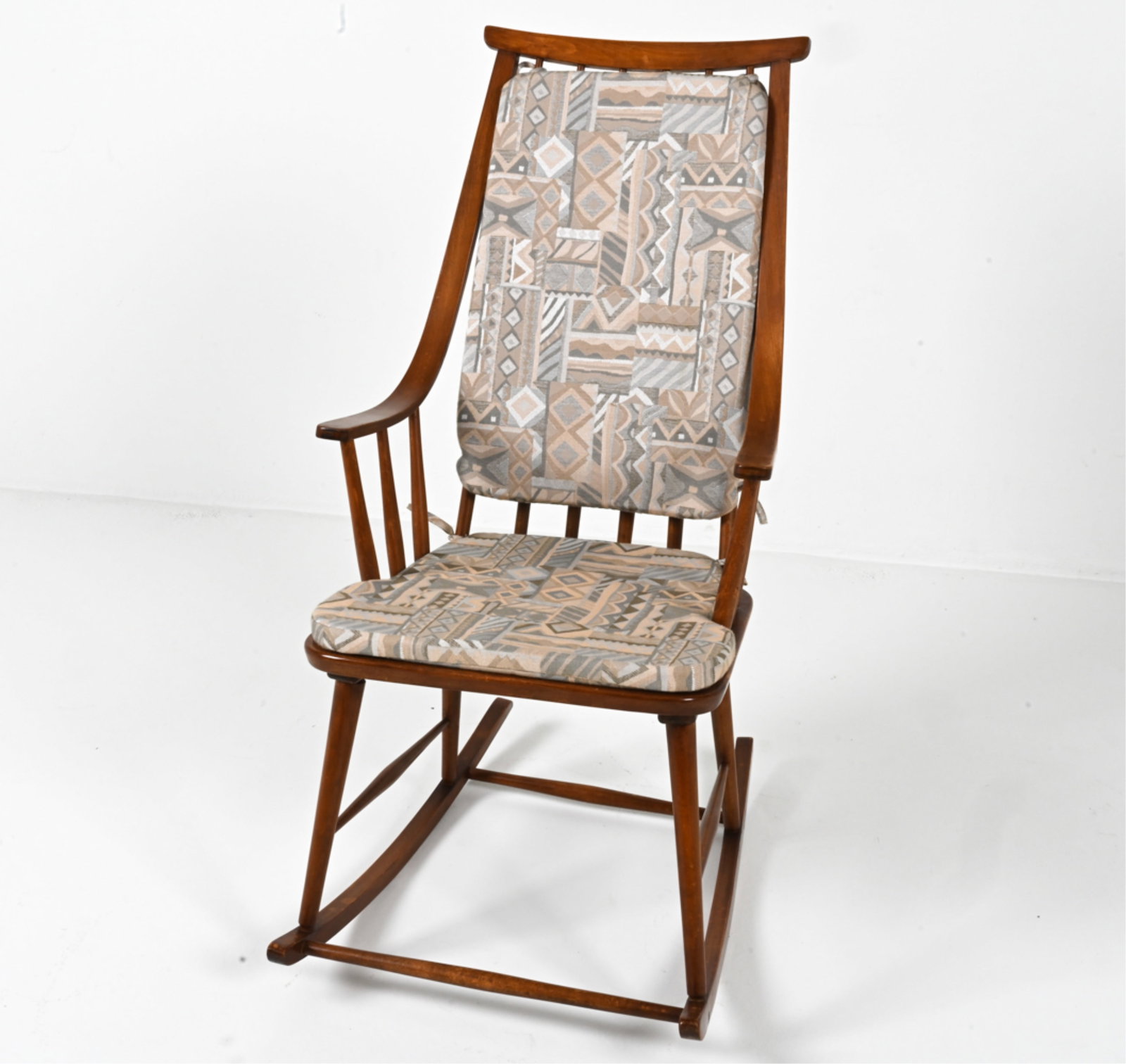 MANNER OF LENA LARSSON SCANDINAVIAN ROCKING CHAIR: Beech spindle-back rocking chair with bent arms, in the manner of Lena Larsson for Nesto. Scandinavian, c. 1960's-1970's. Dimensions: H 43.25" x W 22" x D 30.25". Condition: Spots of discoloration on 