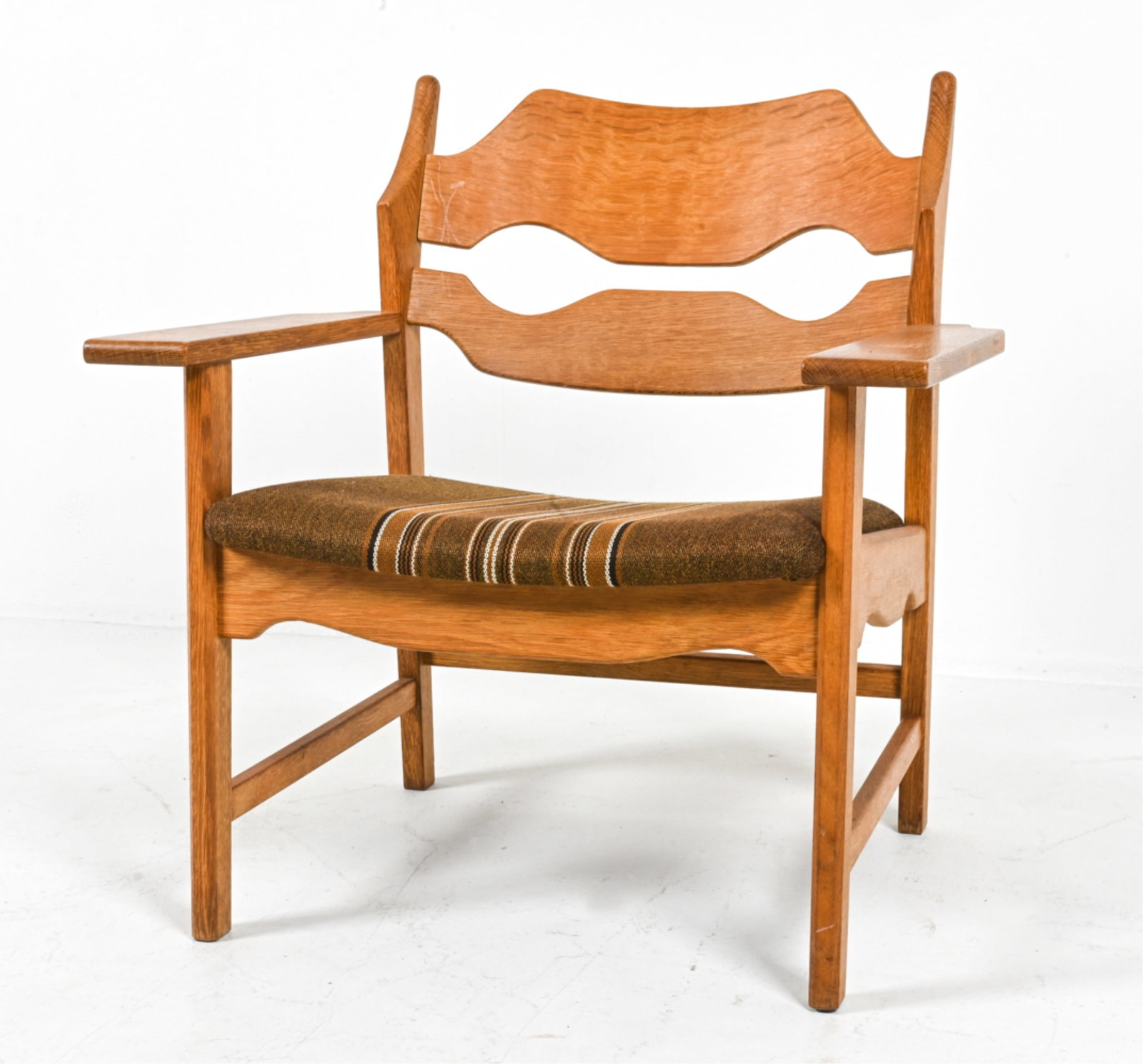 HENNING KJAERNULF OAK RAZOR BLADE LOUNGE CHAIR: Rare quarter-sawn oak armchair with sculpted "Razor Blade" back, designed by Henning (Henry) Kjaernulf for EG Kvalitetsmobel. Denmark, c. 1960's. Dimensions: H 30.5" x W 28.5" x D 26" x SH 16". Condit