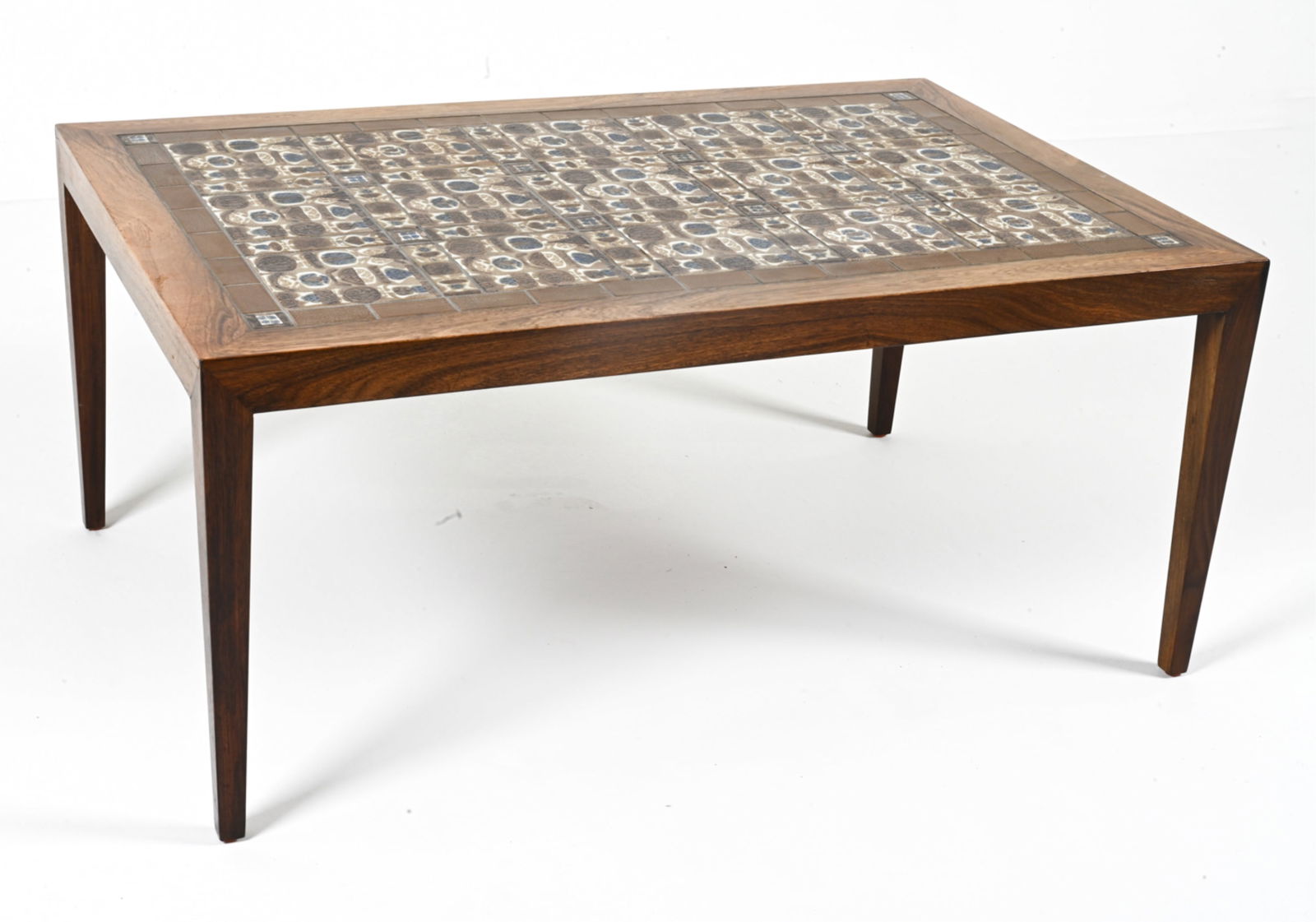 SEVERIN HANSEN NILS THORSSON ROSEWOOD COFFEE TABLE: Rosewood coffee table by Severin Hansen for Haslev, featuring an inlaid mosaic of ceramic tiles from the 'Baca' series, designed by Nils Thorsson for Royal Copenhagen. Denmark, c. 1960's. Dimensions: