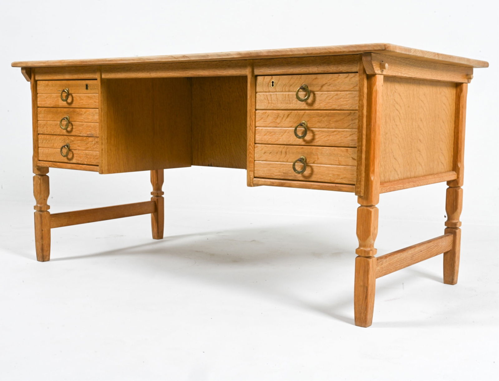 MANNER OF HENNING KJAERNULF OAK EXECUTIVE DESK: Key included. Scandinavian, c. 1970's. Dimensions: H 29" x W 59" x D 30.5". Condition: Wear expected from age and use. B173
