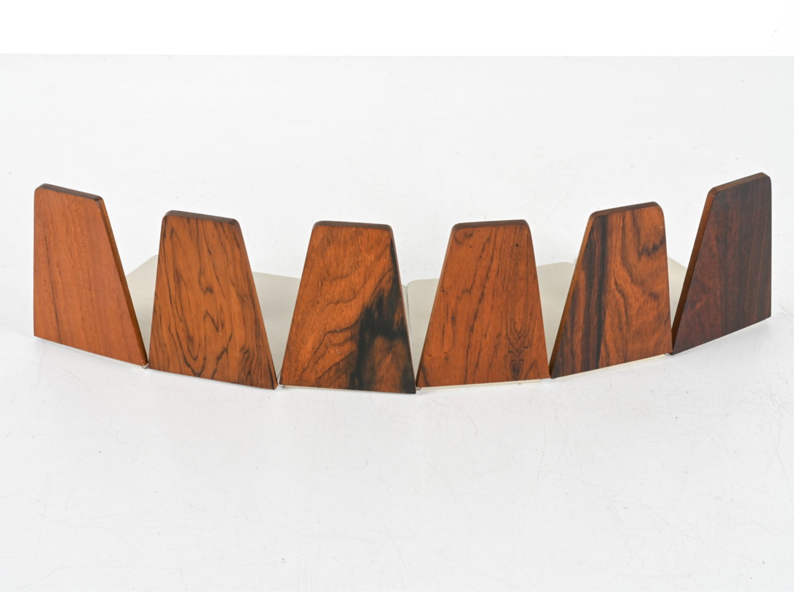 (6) ATTR. KAI KRISTIANSEN BOOKENDS: (5) Rosewood, (1) teak. Dimensions: H 5.25" x W 3.5" x D 5.75". Condition: Light scuffs, chips to finish on wood. Some scuffs to metal.