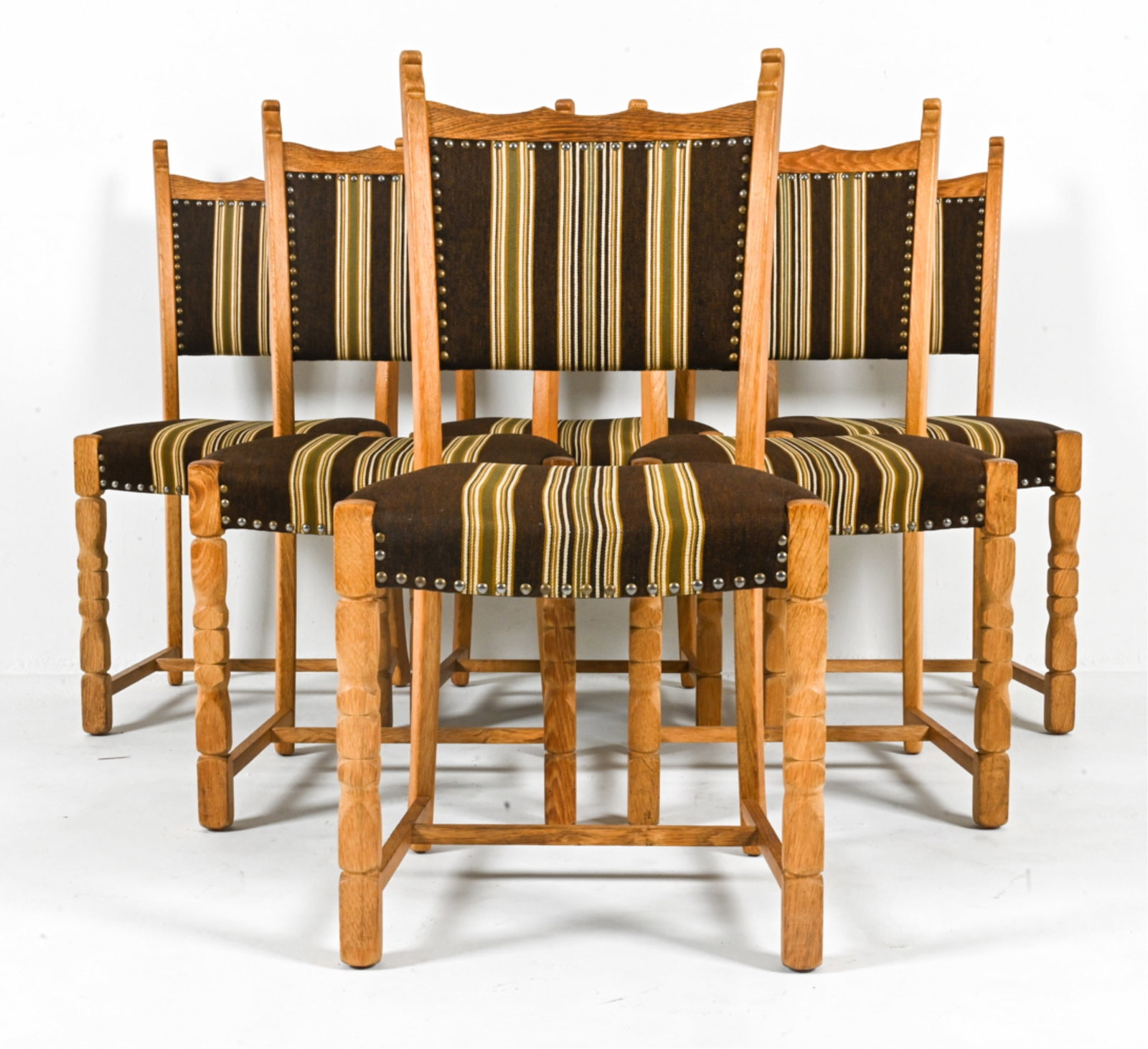 (6) MANNER OF HENNING KJAERNULF OAK DINING CHAIRS: Scandinavian, c. 1970's. Dimensions: H 37" x W 17.5" x D 17.75" x SH 17.5". Condition: Scuffs, scratches on edges. Wear expected from age and use. B082