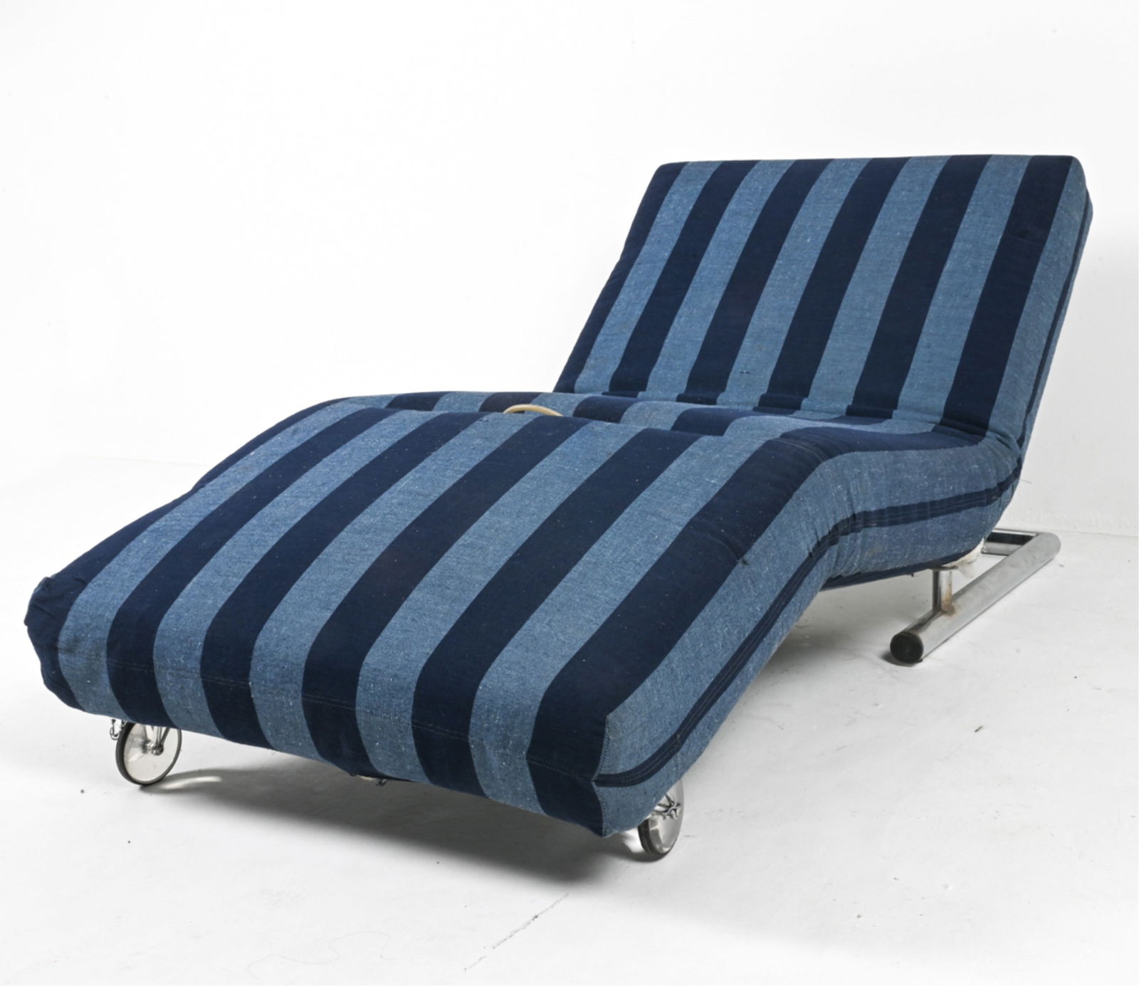 1970'S TUBULAR CHROME ADJUSTABLE CHAISE LOUNGE: With clear casters at one end. c. 1960's-1970's. Dimensions: H 12" x L 76" x D 32.5". Condition: Great candidate for reupholstering; fabric with a few tears at seams, areas of soiling and surface dust