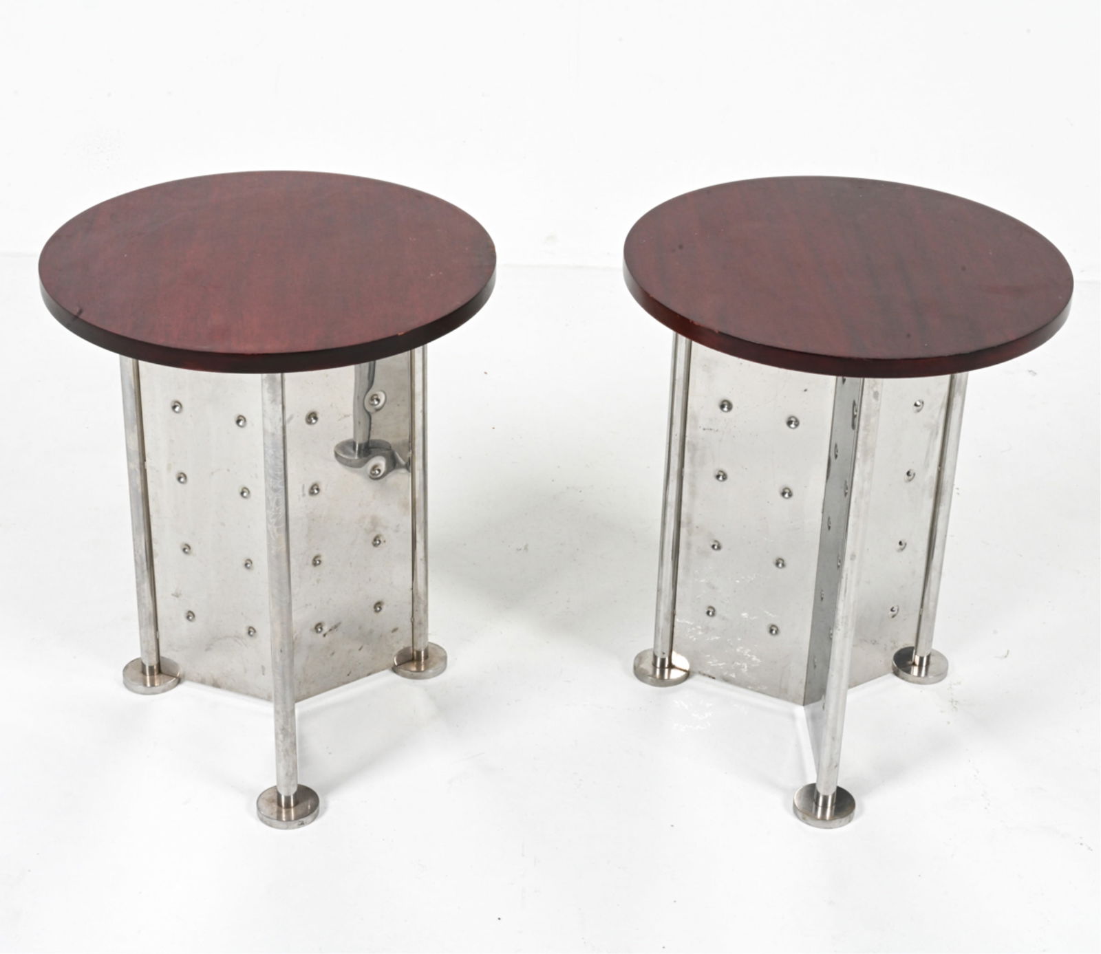 (2) PHILIPPE STARCK TABLES FROM THE ROYALTON HOTEL: Rare pair of side tables in mahogany and polished steel, designed by Philippe Starck for the Royalton Hotel in New York City. c. 1988. Dimensions: H 20" x Dia. 16". Condition: Faint scuffs, scratches