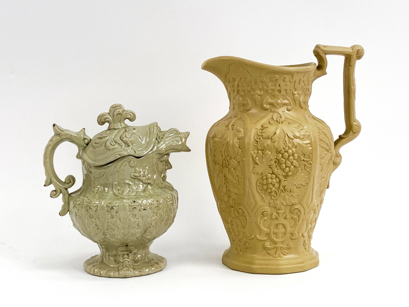 (2) 19TH CENTURY BRITISH JUGS INCL STAFFORDSHIRE: Includes a Staffordshire Viking masks molded jug and cover, 1850's and a Ridgeway and Abington smear glazed harvest jug. Dimensions: (Larger) H 10.75" x W 8.5" x D 6" Condition: No visible breaks or c