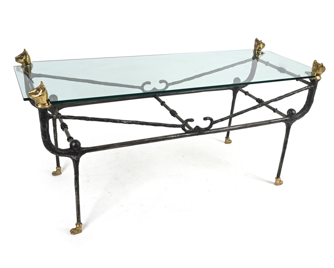 MANNER OF DIEGO GIACOMETTI IRON AND GLASS TABLE: Wrought iron with brass, cat-shaped accents at corners, paw feet. Circa 1980's. Dimension: H 32" x W 66" x D 24.75" Conditions: Oxidation to the base, a few minor scuffs and scratches.