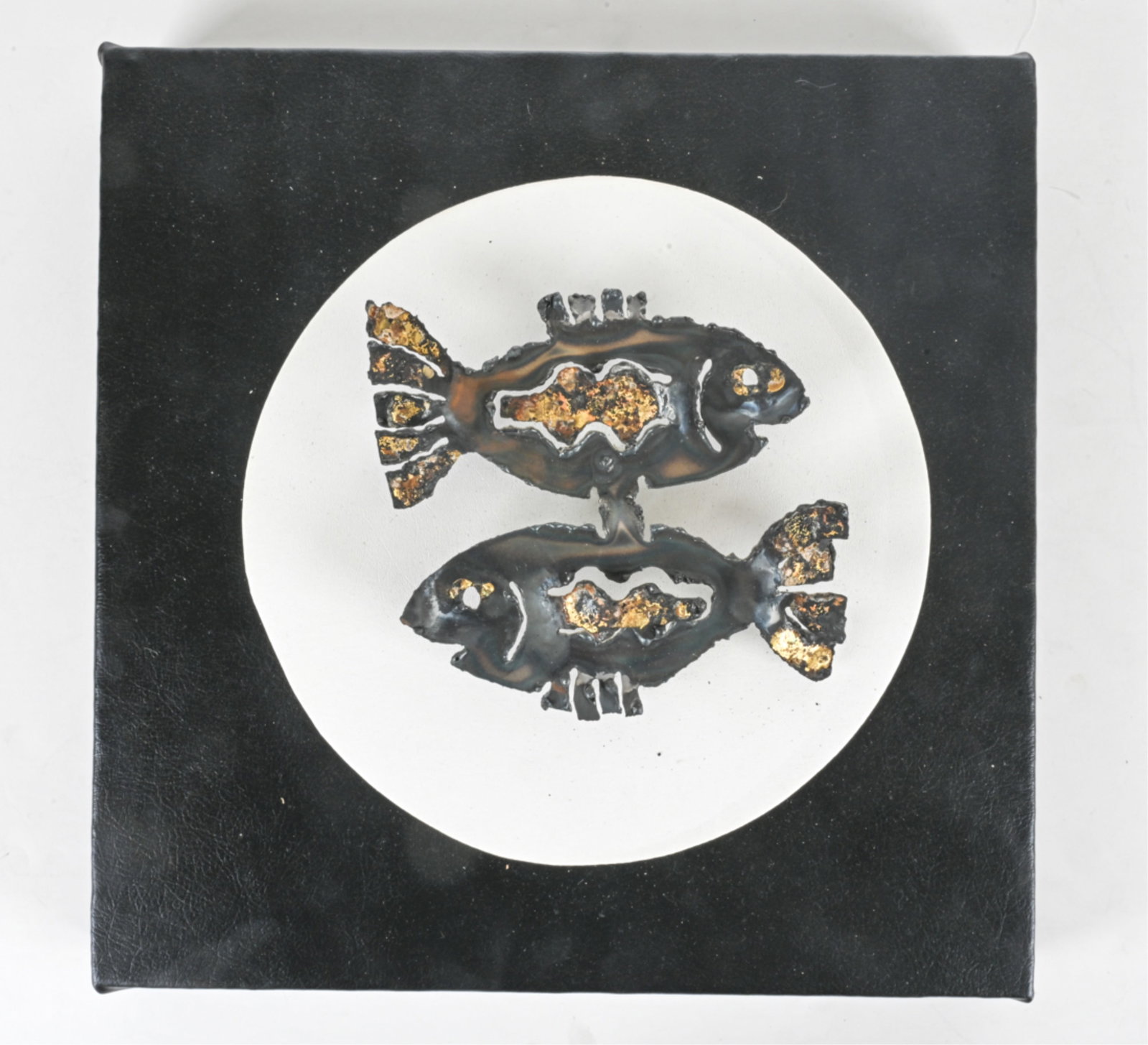 BRUTALIST TORCH-CUT FISH WALL SCULTPURE: Mounted on faux leather wrapped board and wall mounting. Dimensions: H 18" x W 18 " x D 5". Condition: Minor wear to faux leather.