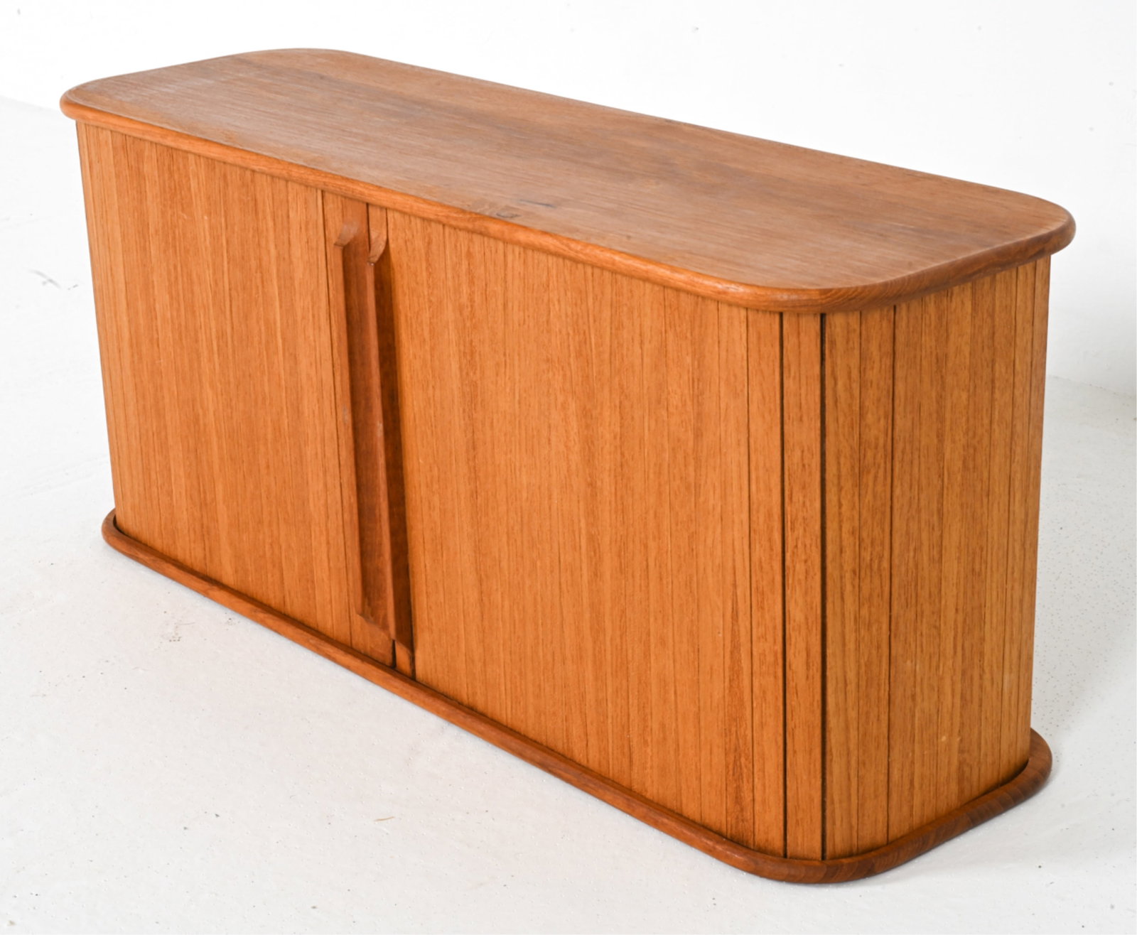 TEAK TAMBOUR-FRONT FLOATING CABINET: Wall-mounted. Teaktech, Dallas Texas. Made in Thailand. Late 20th century. Dimensions: H 9" x W 20.5" x D 6.5". Condition: Minor scuffs inside, good presentation overall.