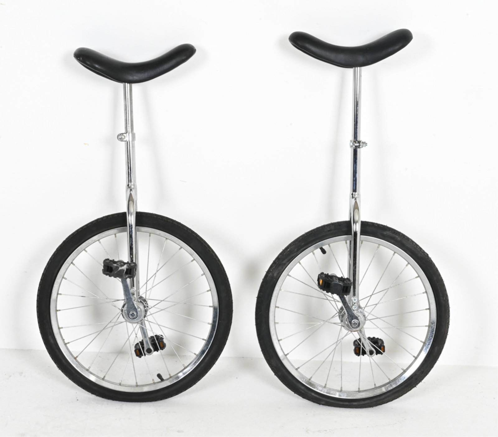 (2) UNICYCLES: Contemporary. Dimensions: H 35" x W 19" x D 17". Condition: Light corrosion, spots of discoloration.