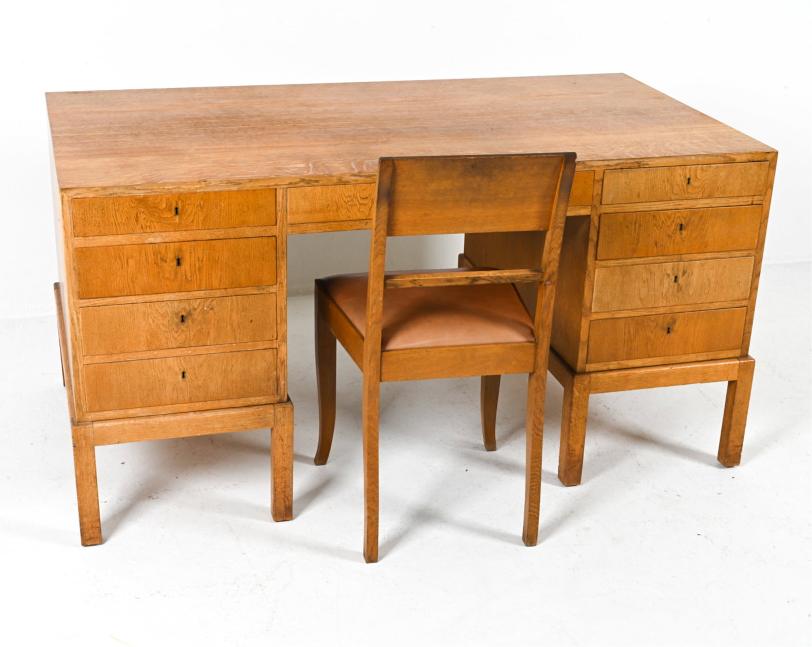 MANNER OF KAARE KLINT OAK EXECUTIVE DESK & CHAIR: With some tiger figuring. Together with oak chair, imitation leather seat. Denmark, circa 1950. Keys included. Dimensions: H 30.25" x W 59" x D 31.25". Condition: Scattered dings and scuffs; minor sun