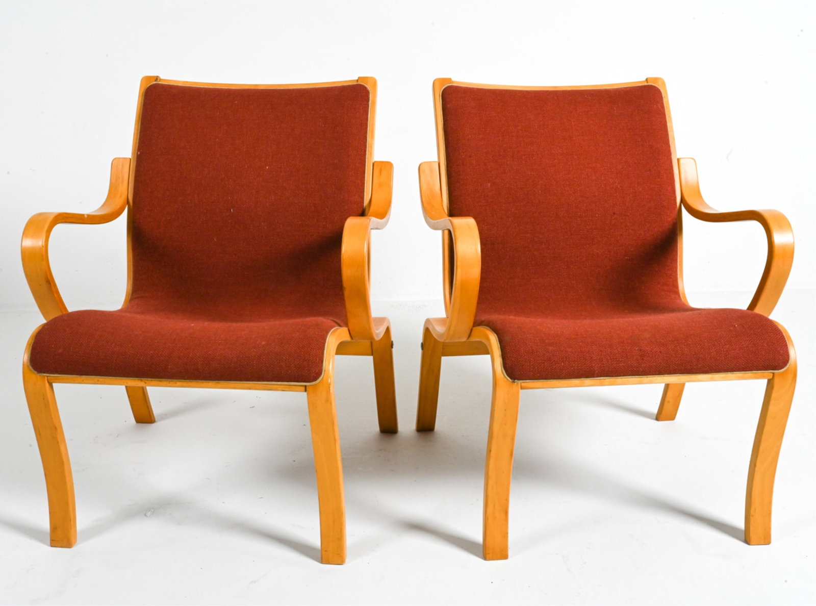 (2) MANNER OF BRUNO MATHSSON BENTWOOD ARMCHAIRS: Beech wood and fabric. Possibly a Finn Ostergaard design. Scandinavian, c. Late 20th Century. Dimensions: H 30.5" x W 24" x D 28" x D 16". Condition: Minor fading, a few spots of soiling to fabric. A