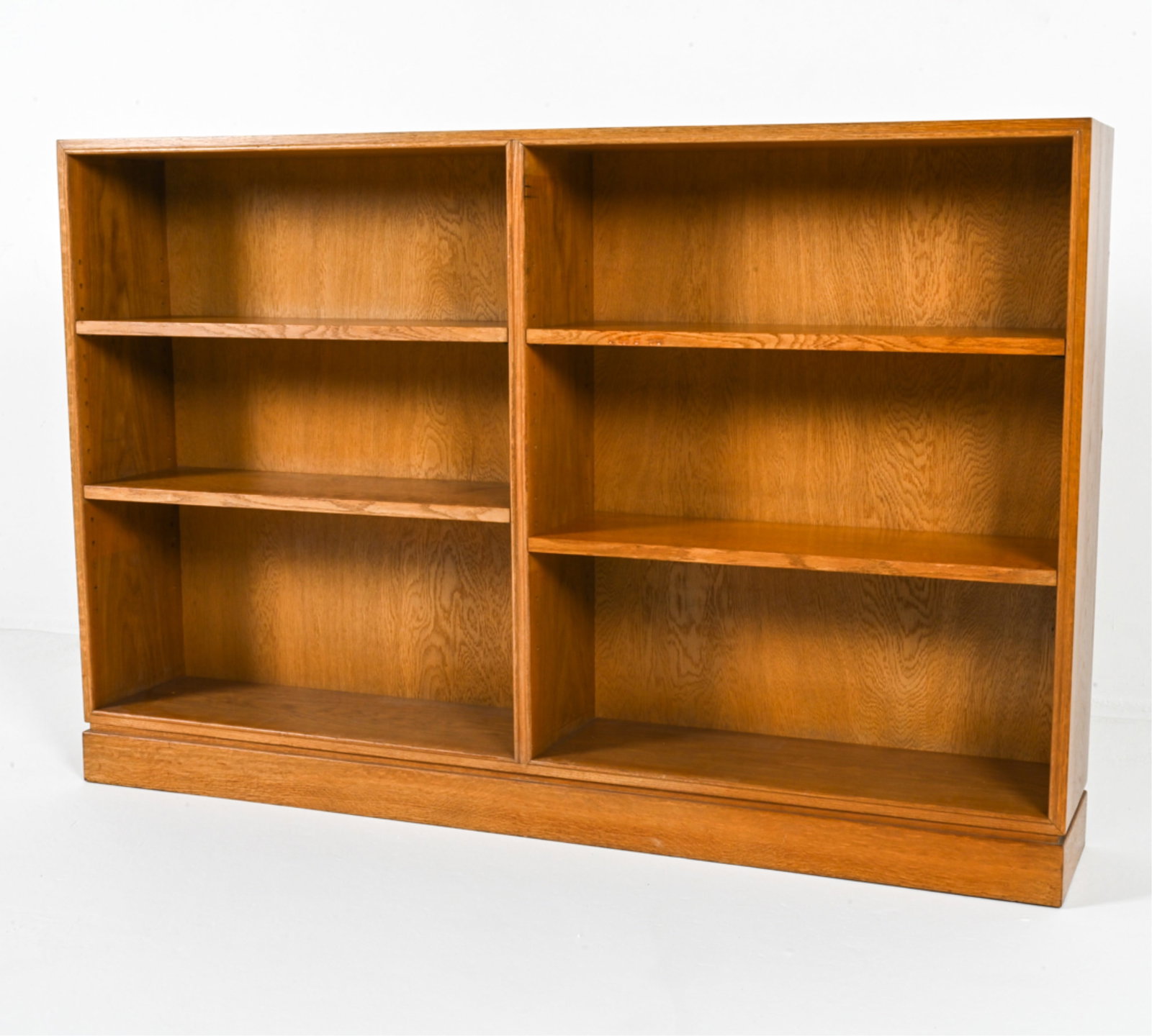 DANISH OAK BOOKCASE BY FRITS HENNINGSEN, C. 1940'S: With adjustable shelves. Dimensions: H 29" x W 59.25" x D 9.5". Condition: Two wear spots through veneer on top. Scuffs, scratches, and dings, minor areas of discoloration. Wear consistent with age an